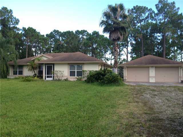 GREAT 3/2 SPACIOUS HOME ON A PAVED ROAD WITH A LARGE 600 DETATCHED GARAGE ON A FULLY FENCED OVERSIZED LOT.  SPLIT PLAN LARGE FAMILY, LIVING AND DINING ROOM AND TILED THRU OUT. BIG OPEN KITCHEN WITH LOTS OF CABINETS WITH A LARGE ROOFED COVERED PATIO OVERLOOKING A NICE BEAUTIFUL PRIVATE TREED LOT.  WILL BE AVAILABLE JUNE 1, 2026  BETTER PICTURES COMING SOON,  2022 NEW ROOF 2022, NEW A/C, AND WATER SYSTEM.