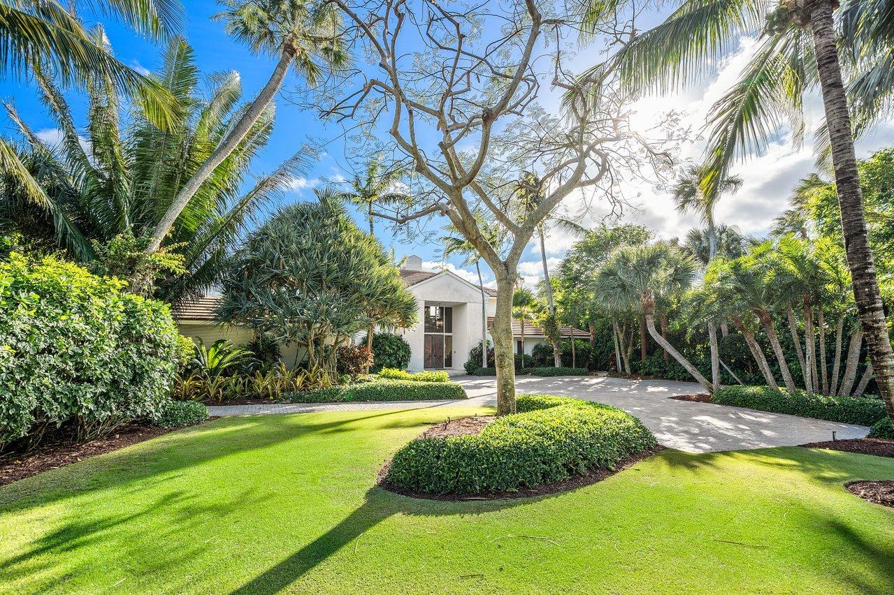 Luxurious living in this prime deep waterfront home. Enjoy the fabulous views and incredible sunsets. Double height ceilings in living room. Very large master suite with seating area and balcony overlooking the pool and the water. Full house generator. Golf, ocean, tennis, marina, fitness center, oceanfront country club, private gated community.
