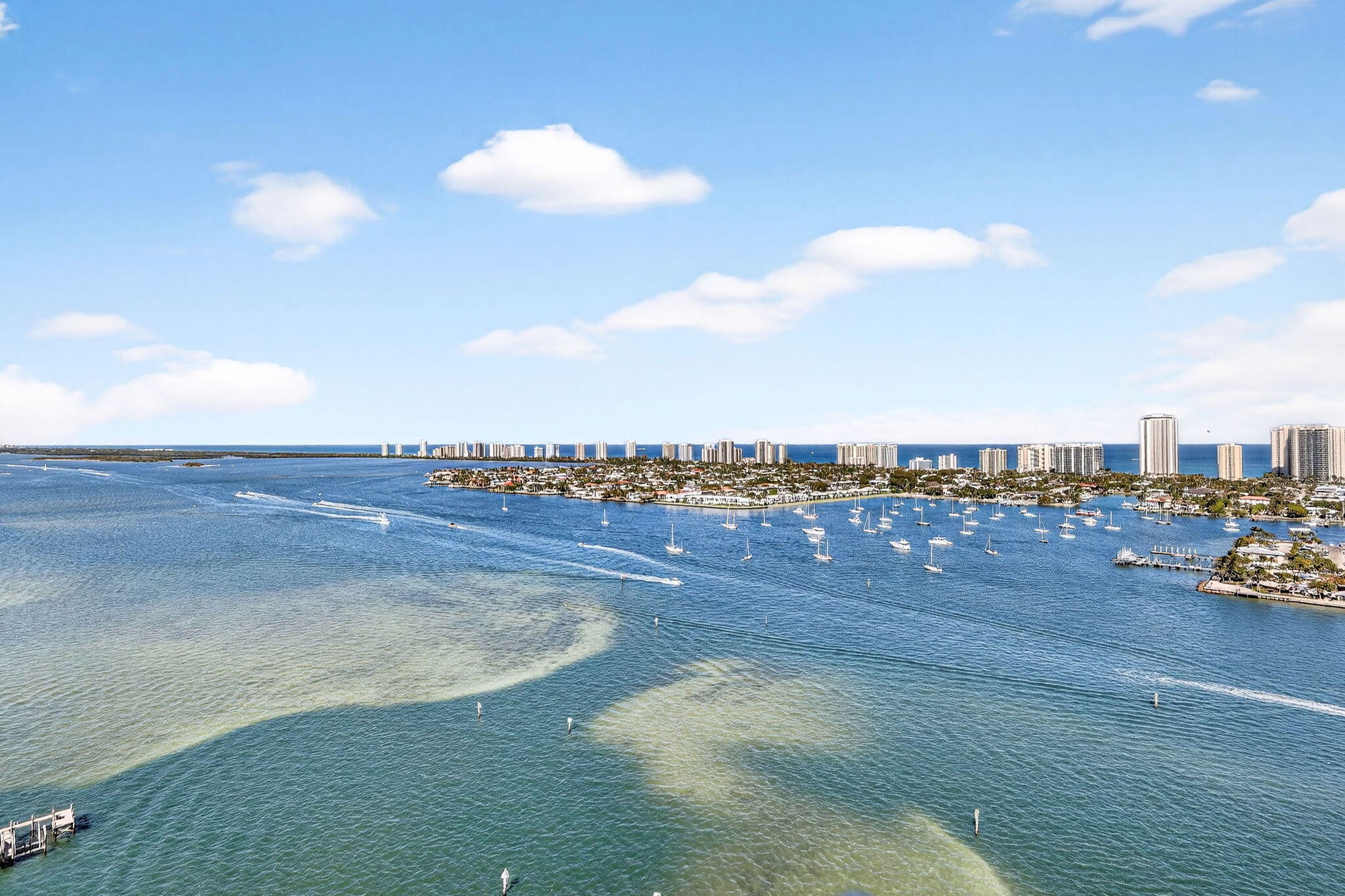 Rarely available penthouse residence at Marina Grande offering elevated luxury living with soaring 11-foot ceilings and breathtaking panoramic views of the Intracoastal Waterway, Atlantic Ocean and Singer Island. Located in the desirable 2608 stack, this exceptional sky-high condo is a rare opportunity in one of the area's premier waterfront communities.  This spacious 3-bedroom, 3-bath residence features a bright open floor plan with floor-to-ceiling impact glass and skylights, filling the living spaces with natural light and showcasing stunning views from the main living areas and bedrooms. The kitchen is appointed with tray ceilings, granite countertops, quality cabinetry, newer stainless steel appliances and ample prep space, ideal for both everyday living and entertaining. Crown  molding throughout adds an elegant touch.   Move-in ready and offered fully furnished, this home features wood flooring throughout with tile in the bathrooms creating a warm sophisticated coastal feel. The primary suite offers a private retreat with luxurious bath accommodations and generous closet spaces, while two additional bedrooms provide flexibility for guests, family, or a home office.  Additional conveniences include one assigned covered parking space, guest parking available in the garage, and a private storage cage.  Marina Grande residents enjoy resort-style amenities including a manned guard gate, community activities, fitness center, pool, spa, tennis/pickleball courts, clubhouse, billiards room, card room, and nearby onsite marina access with dry docks. Ideally located minutes from Singer Island beaches, waterfront dining, shopping, Peanut Island and the Palm Beach Inlet with no fixed bridges.   A rare penthouse opportunity—ready to enjoy immediately.