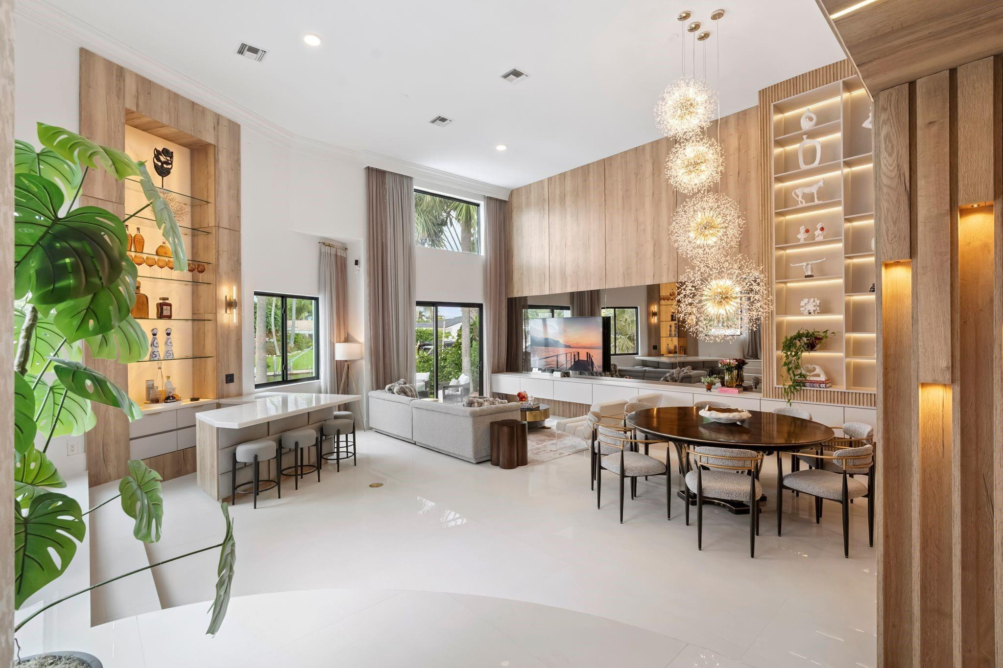 Discover the epitome of luxury living with this completely renovated, designer-inspired home offering a new seawall & dock (paid for but not yet complete), new roof, all new AC units, new impact glass windows, new tankless hot water heater and all new pool equipment. The kitchen is a chef's dream, complete with an island, an adjacent dining area for entertaining, & a hidden pantry. The ground-level primary bedroom is a sanctuary of comfort, boasting 10 foot ceilings, porcelain floors, wet bar,spacious walk-in closets, and secret entry to the pool.  Positioned with 80' of waterfrontage, and only minutes to the ocean, this is a boaters dream! Just minutes from Publix, Whole Foods, tons of restaurants.
