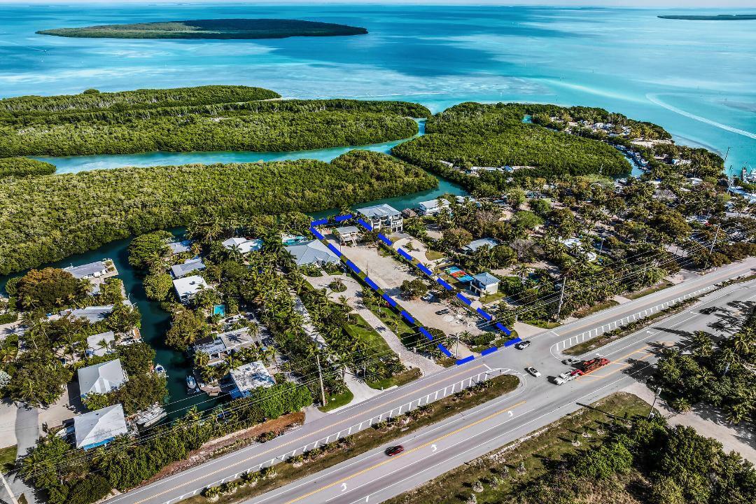 Estate Opportunity -  Spanning 34,409 SF, this exceptional parcel offers a scale uncommon in Islamorada, providing the foundation for a spectacular Florida Keys residential estate. The exceptional lot size allows a discerning buyer to imagine the best. The site easily accommodates the vision of an estate property with pool, tennis or pickleball court, expansive outdoor living, caretaker's cottage, and generous waterfront dockage--all while maintaining privacy rarely achieved in the Keys. Positioned on a deep basin, the property provides protected dockage while being only seconds from Florida Bay and minutes under the bridge to the Atlantic Ocean, placing world-class backcountry and offshore fishing within immediate reach. The 2/2 pool home is updated and ready for refined living.