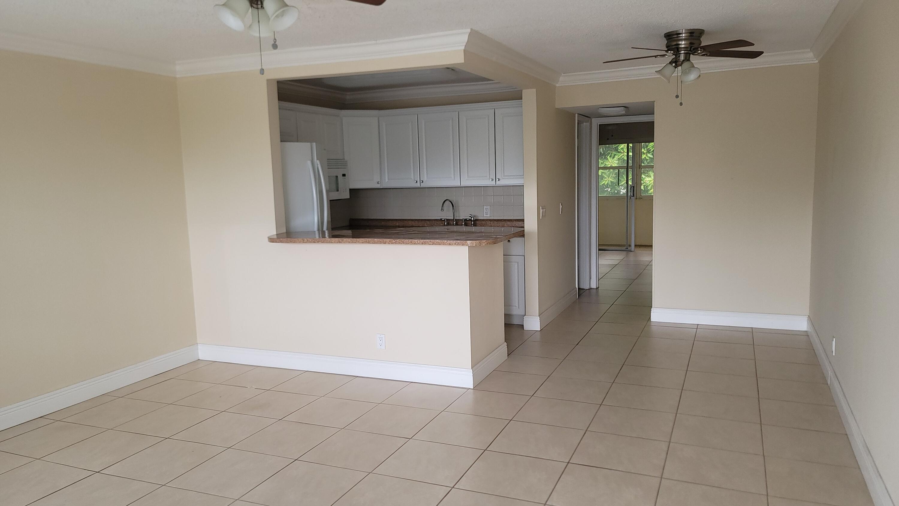 Very clean, bright, and well-maintained 1-bedroom, 1-bath second-floor condominium offered unfurnished. The updated kitchen and bathroom feature tasteful renovations, while newer appliances add convenience and value. A/C units in both the living room and bedroom provide year-round comfort. Ideally located near the Okeechobee Gate for easy access to shopping, dining, transportation, and all community amenities. Move-in ready and a great opportunity to enjoy South Florida living. Experience resort-style living in the highly desirable Century Village West Palm Beach, a gated 55+ community with 24-hour security and exceptional amenities. Residents enjoy a spectacular 92,000-square-foot clubhouse featuring a theater with live entertainment and free movies, fitness facilities, indoor and outdoor pools, billiards, card and craft rooms, library, dance and exercise classes, tennis, shuffleboard, bocce, and countless social activities. Courtesy transportation throughout the community and to nearby shopping, dining, and services adds to the convenience.  Ideally located just minutes from Palm Beach International Airport, Florida's Turnpike, I-95, downtown West Palm Beach, Rosemary Square, shopping, dining, and South Florida's beautiful beaches. Move-in ready and a must-see!