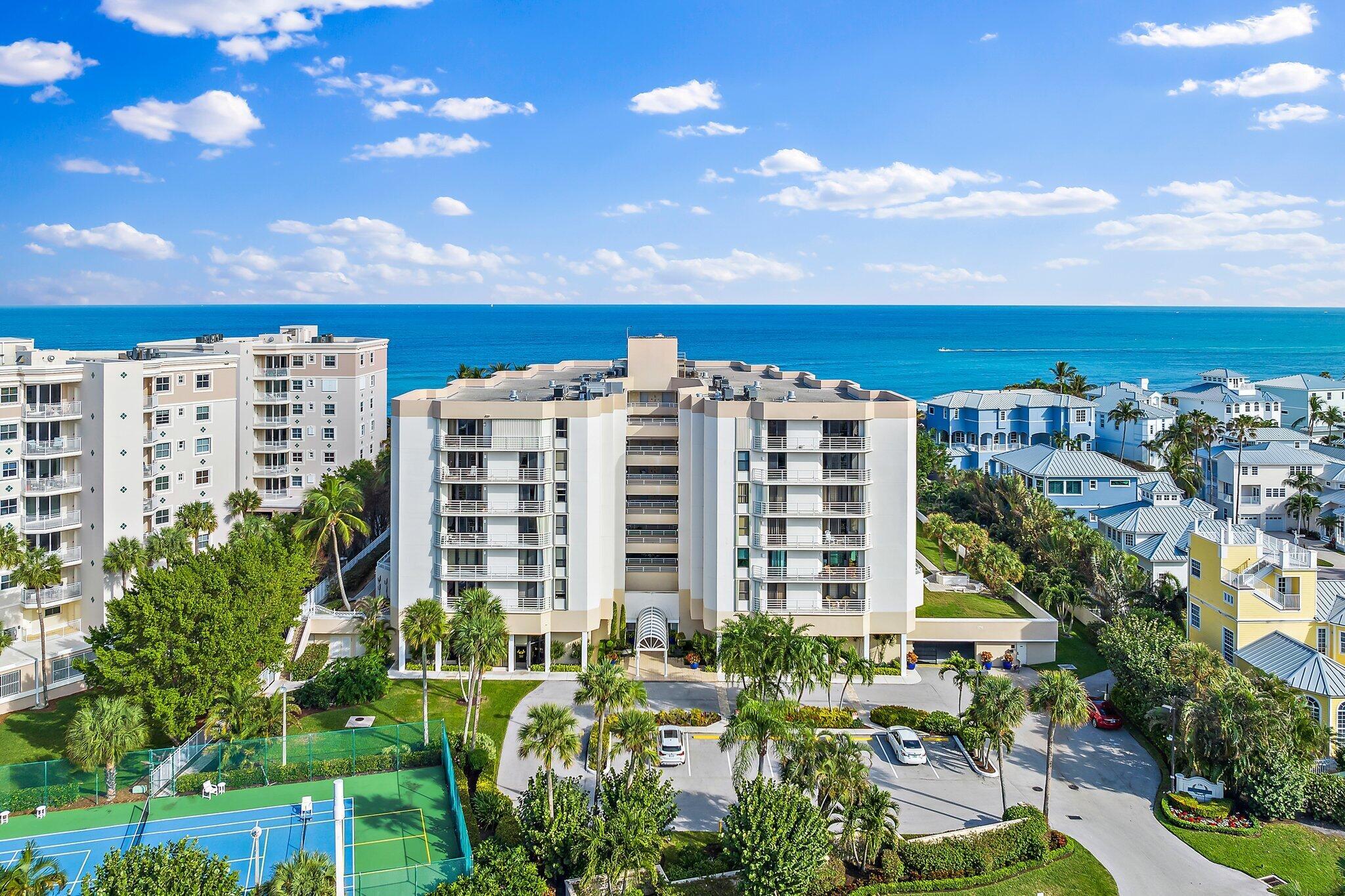 This beautifully updated 3 BR, 2.5 BA corner unit offers approximately 1,900 SF  with lovely ocean views!  This open-concept layout condo features luxury vinyl plank flooring throughout, HUGE quartz kitchen island, stainless steel appliances, spacious split bedroom floor plan, water views from every bedroom, garage parking, fully furnished with upscale furnishings including luxurious white leather sectional in the living area. An incredible value-add for buyers, as the owner paid approx 180k in assessments allowing the next owner to enjoy benefits of the community's extensive improvements. The bldg is currently completing installation of a new resort-style pool, making this an exceptional time to purchase in The Corinthians.  Ideally located near premier dining & shopping.  A GEM!