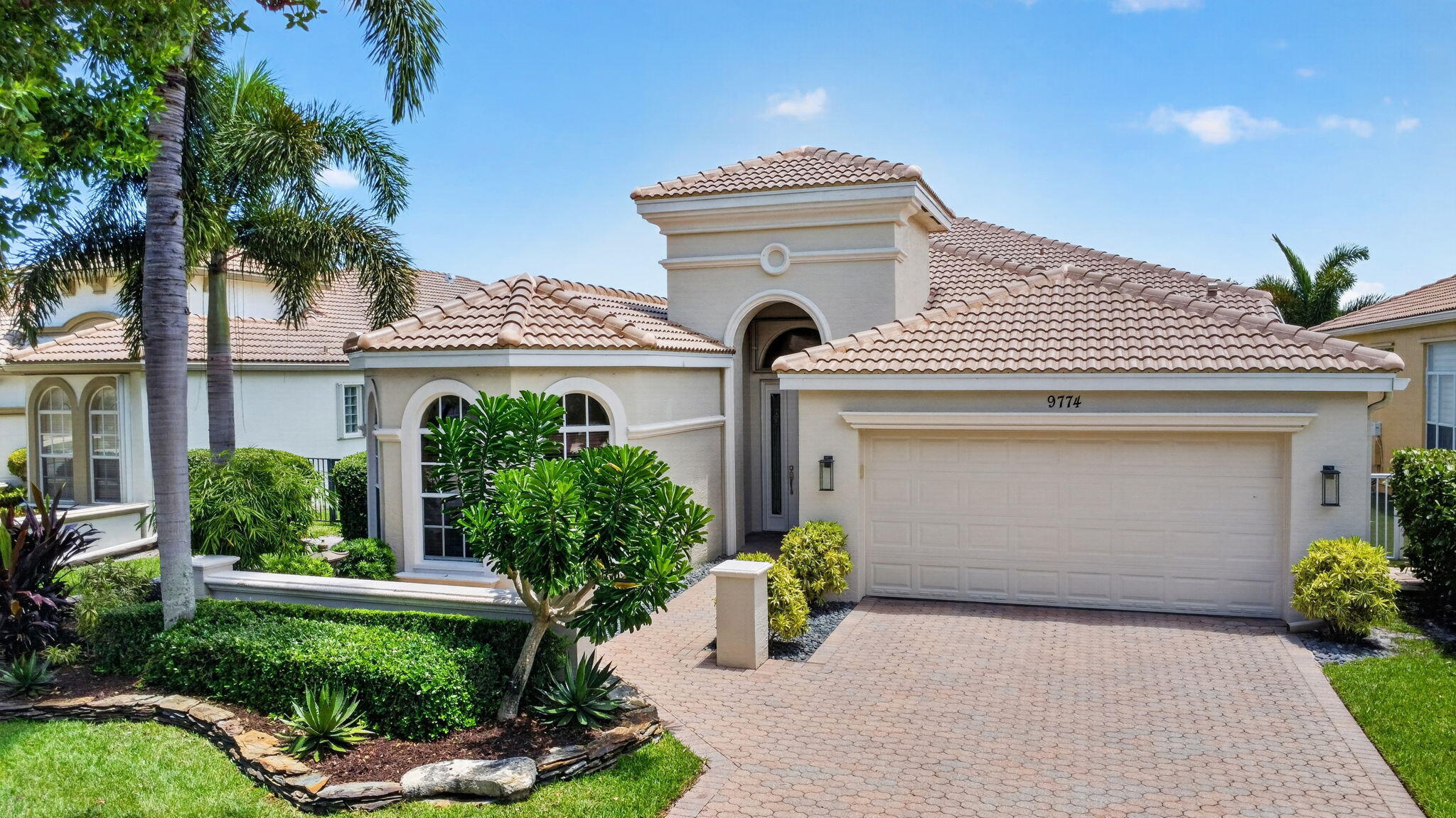 Welcome to the most sought-after floor plan in Buena Vida! This rarely available meticulously maintained Triana model sits on a premier waterfront lot w/ an easement along the east side, creating an expansive feel & additional patio pavers for a peaceful outdoor dining area and offers a HEATED SALT WATER POOL, NEW ROOF (2026) & NEW A/C (2025), providing peace of mind for years to come.  From the moment you arrive, you'll be impressed by the elegant paver walkway, private courtyard entry, & phantom screen front door, welcoming you into a light-filled home that perfectly blends style and functionality.  Designed w/ both beauty & practicality in mind, this home features neutral tile set on the diagonal, plantation shutters in select rooms, abundant high-hat lighting, partial accordion ... hurricane shutters, clear storm panels for the front windows, an impact glass front entry door with sidelight, a portable generator transfer switch, and a dedicated electrical outlet for an electric vehicle charger. The spacious kitchen is ideal for everyday living and entertaining, offering elegant cabinetry, granite countertops, stainless-steel appliances, a desirable induction cooktop, a built-in desk area, and a sunny breakfast nook with bay windows overlooking tranquil lake views. Retreat to the luxurious primary suite featuring beautiful travertine marble flooring, oversized windows showcasing peaceful water views, private access to the screened patio, dual walk-in closets, and a spa-inspired ensuite complete with dual vanities, a makeup vanity, soaking tub, and walk-in shower. A comfortable guest bedroom and oversized den provide flexible space for visiting family, a home office, or hobby room. Step outside to your private screened lanai where a heated saltwater pool, desirable southern exposure, and serene waterfront setting create the perfect backdrop for relaxing or entertaining year-round. This exceptional home seamlessly combines timeless elegance, thoughtful upgrades, and everyday practicality, making it the perfect opportunity to enjoy the very best of the South Florida lifestyle.  HOA FEE INCLUDES: Man-guarded gated entry, lanscaping, cable with a premium channel, internet and $500 a year ($41.66/mo.) of your HOA fees goes towards your cafe' card for purchasing food & beverage at the cafe'.  Buena Vida is Wellington's premier boutique 55+ active community offering a newly renovated clubhouse and marvelous amenities such as: Resort Style Pools, Cafe, Spa, Sauna, 4 NEW PICKLE BALL COURTS, 6 Har-Tru Tennis Court, State of the Art Fitness Center, Library, Card Rooms, Billiard Room and entertainment in the luxurious Ballroom - just to name a few! Offering the BEST location in Wellington, Buena Vida is just minutes to great restaurants, shopping, entertainment, Wellington International Equestrian events, parks and top-notch medical facilities, yet also close to the beaches, cultural venues, downtown areas & PBI International Airport. Luxuries abound in this well-manicured community with all the indulgence you deserve. ** Wellington, FL made the Forbes Magazine's list of 50 Best Places to Live for the second consecutive year (2023/24).
