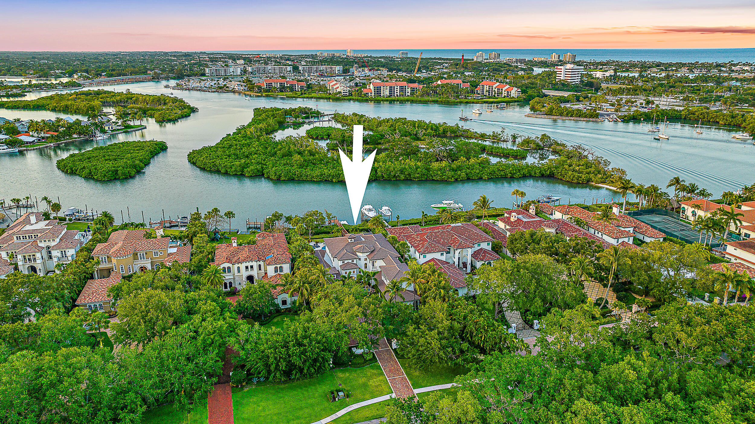 Discover unparalleled luxury at 337 Old Jupiter Beach Road, an exquisite 5-bedroom, 6.5-bathroom grand waterfront estate nestled in the tranquil and prestigious Sanctuary Bay neighborhood of Jupiter. Situated on a tranquil and private lot with 90 ft of direct Intracoastal waterway frontage, the property on nearly 3/4ths of an acre boasts breathtaking views across a protected preserve of Fullerton Island. The well-designed outdoor space includes a covered patio, an outdoor kitchen, and a luxurious pool and spa, perfect for entertaining or private relaxation by your own private sandy beach area. This custom-designed property offers privacy and elegance on one of the area's most idyllic streets with no through traffic, setting a new standard for high-end living. The interior features high ceilings and custom millwork throughout, enhancing the open, airy feel. A gourmet kitchen equipped with a gas range, island prep station, views of the pool & intracoastal make preparing and eating a delight. Luxurious living spaces include a loft, a media room (optional 6th bedroom), and a separate apartment, offering versatile living options. Stunning ceiling work, all-marble flooring, and beautifully appointed impact windows & doors underscore the home's exquisite attention to detail. Enjoy unrestricted access to the open ocean with a short boat ride from your deepwater dockage. Electric screens on the second-floor lanai provide comfort and privacy, perfect for enjoying scenic, peaceful views. Ample outdoor parking and a majestic wrought iron entry gate add security and grandeur. Just a few short minutes to your favorite places like Starbucks and Fresh Market or take a short kayak trip to Harborside from your backyard, this property is more than just a home - it's a lifestyle, promising serene, luxurious living that's simply unmatched.