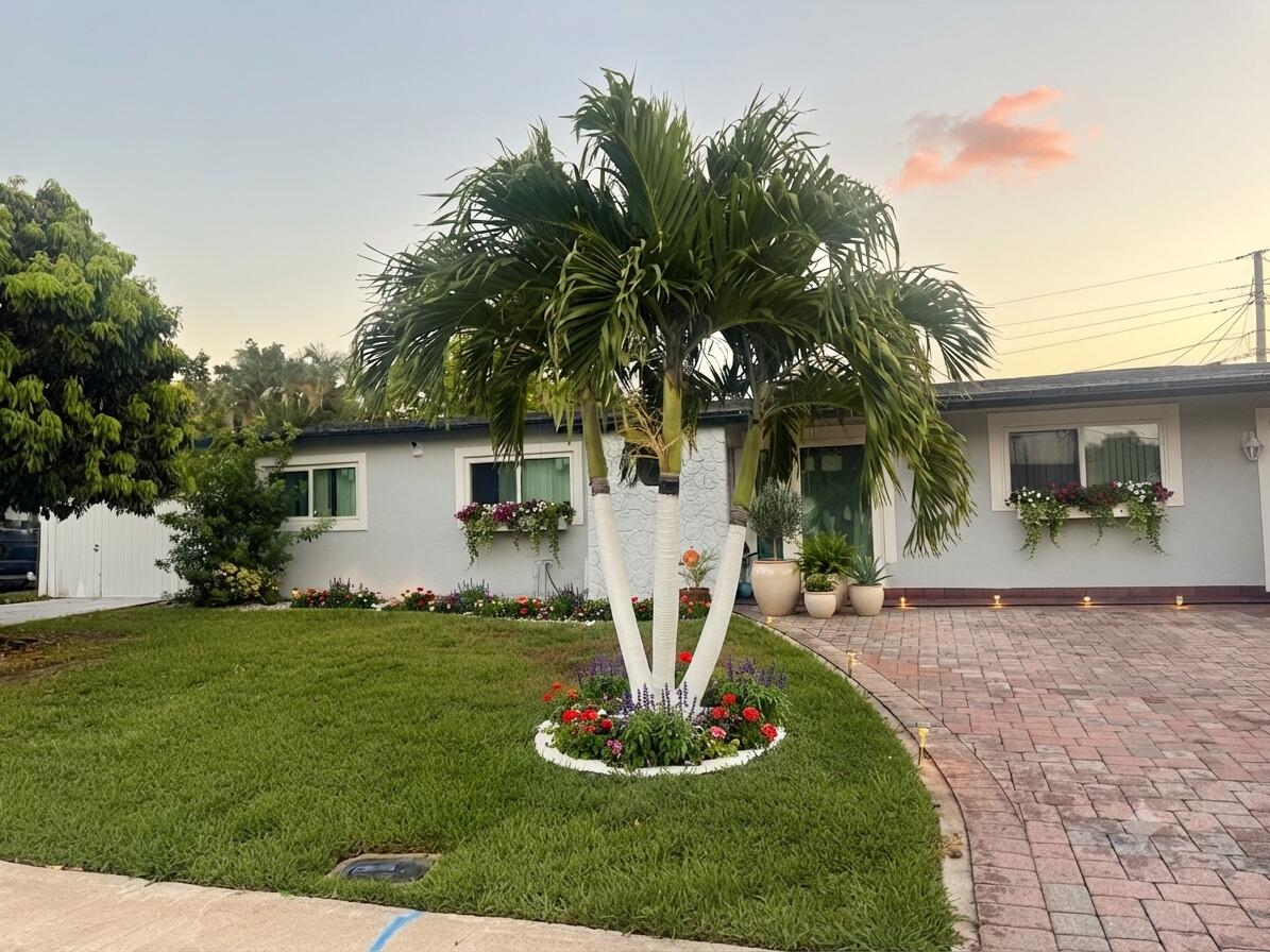 Discover the perfect blend of comfort, space, and convenience in this beautifully maintained single-family home, ideally situated just minutes from Trump International Golf Club. Enjoy easy access to shopping, dining, Palm Beach International Airport, and I-95, making everyday living both convenient and enjoyable. No HOA and no restrictions! Bring your RV, boat, work trucks, or multiple vehicles with ease. In addition to the one-car garage, the oversized driveway provides parking for 4 to 5 additional vehicles. This spacious home features 4 bedrooms, 2 full bathrooms, an open-concept floor plan, a modern kitchen with granite countertops, tile flooring throughout, a dedicated laundry room, and a utility room. Step outside to your private backyard oasis, complete with a sparkling swimming  and mature fruit trees, including soursop (guanabana), Major updates include a roof replaced approximately four years ago and an A/C system that is also approximately four years old, providing added value and peace of mind. The property also features a brand-new white fence and impact-resistant doors and windows, offering enhanced privacy, security, and protection. This exceptional property offers the perfect combination of comfort, flexibility, and outdoor living. Schedule your private showing today!