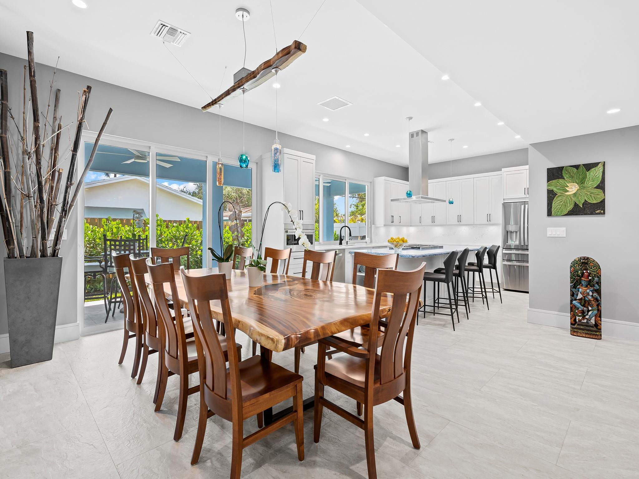 Welcome to this beautifully remodeled 3-bedroom, 3-bathroom residence in the highly sought-after Lake Placid subdivision of Lighthouse Point. Spanning 2,693 sq ft of living area, this open-concept home boasts porcelain tile, and LED recessed lighting throughout. The oversized kitchen features a Wolf gas stove, dual Bosch dishwashers, custom wood cabinets, quartz countertops, and a large pantry. Enjoy a bonus room, walk-up bar with a wine cooler, and a fenced backyard with a covered patio prepped for an outdoor kitchen. Upgrades include a new metal roof (2024), impact windows, new PVC piping, updated electrical panel and a 50 AMP car charging outlet. A must see! Beautifully renovated, move in condition.