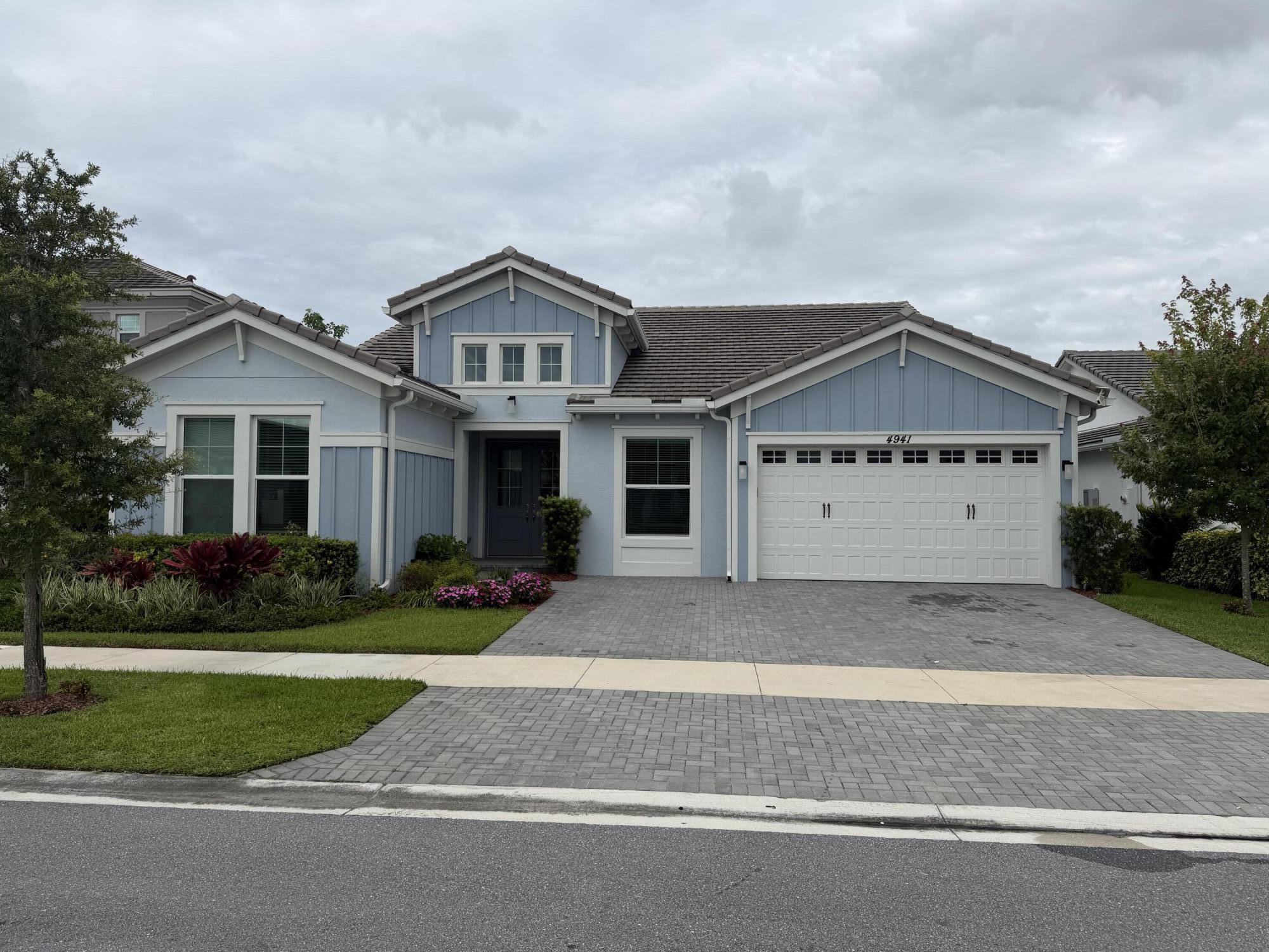 Beautiful newer construction waterfront home with a large lot in the sought-after gated community of The Orchards at Westlake. Built in 2023, this expansive one-story residence features 4 bedrooms, 4 bathrooms, plus a dedicated office and hobby room both with built in cabinetry, offering an ideal layout for both everyday living and entertaining. Enjoy serene lake views and a long list of upgrades including wood plank tile throughout, custom built-in closets, an upgraded kitchen with an extended quartz island, full impact glass windows and a motorized patio screen for seamless indoor-outdoor living. The home also includes a Tonal gym system. Residents enjoy resort-style amenities including a spectacular pool with towering water slide, basketball courts, and a beautiful community lodge.