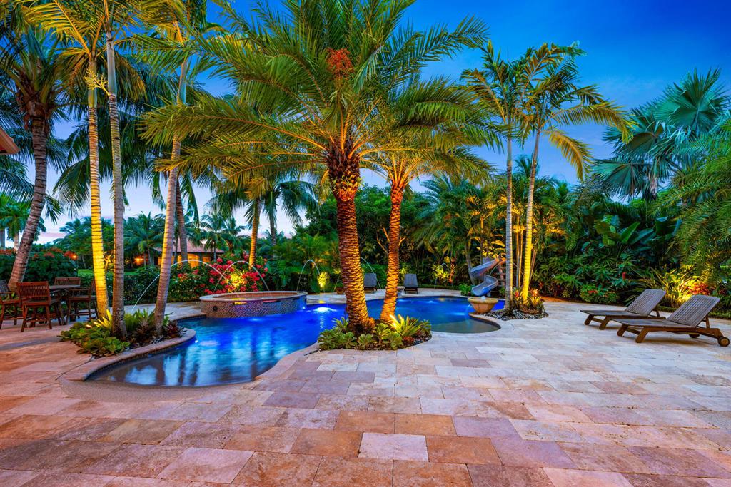 Impeccably landscaped facility on a 5 acre corner lot with gated house and barn entrances. The main residence boasts 4 bedrooms all with en-suite baths, office and additional media room plus a chef's kitchen and impact glass. Smart home enabled system with security cameras for house, gates and barn. Enjoy the utmost in outdoor living with an expansive patio area including built in bar and summer kitchen overlooking the custom saltwater pool and 200' x 125' GGT ring. Features a barn with 8 stalls (room for 12), wide aisle, tongue and groove ceiling, multiple grooming stalls, tackroom, feedroom and recessed equine treadmill. Recently remodeled to add additional storage and multiple staff quarters.