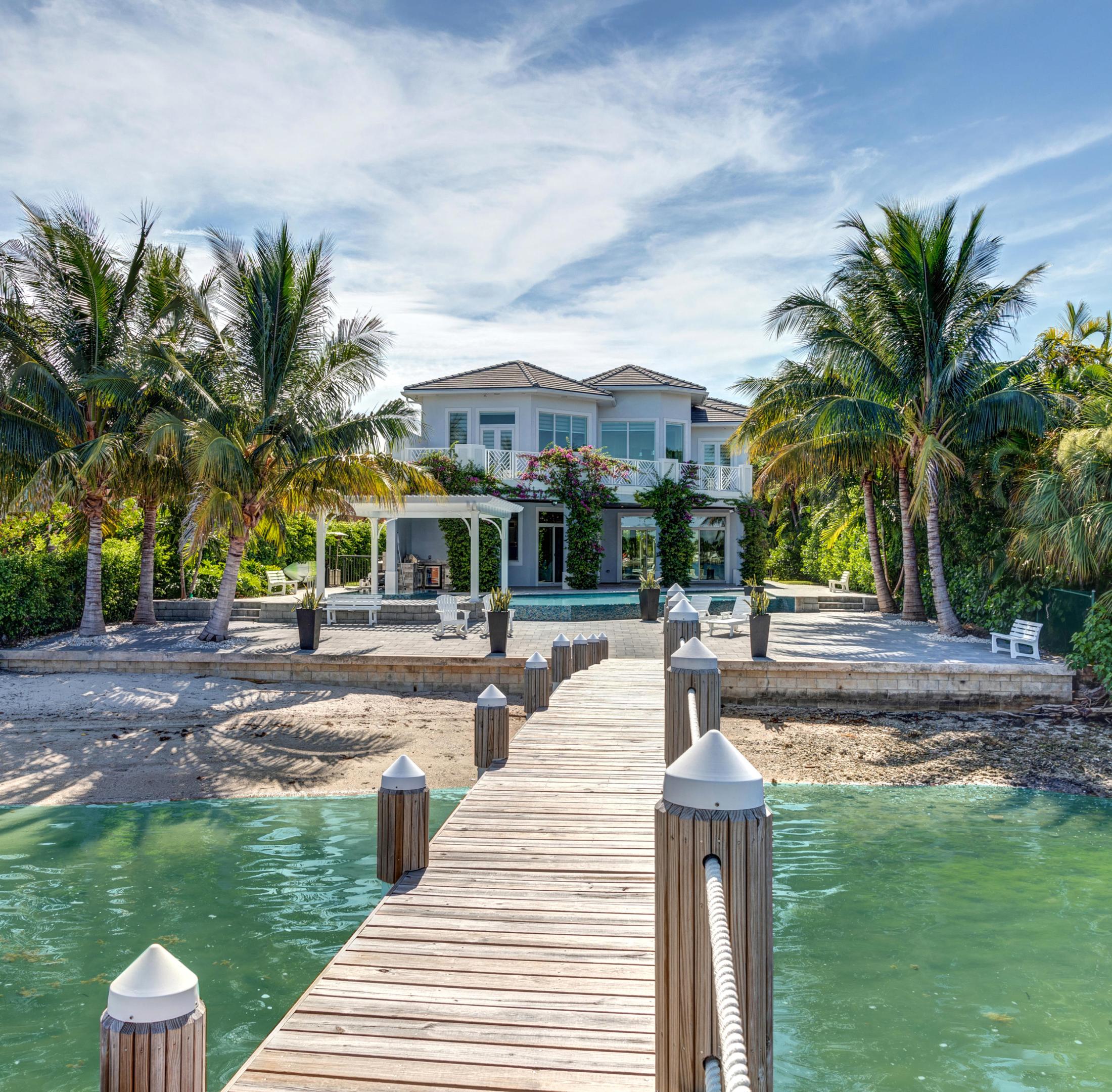 A BOATER'S DREAM HOME in a NO WAKE ZONE. 150 ft dock that can accommodate multiple boats. 2 additional 30 ft floating docks. Expansive views of the Intracoastal Waterway. Contemporary design that's LESS THAN 3 YRS OLD. Phenomenal natural light throughout the home. Ideal for indoor & outdoor living. GOURMET KITCHEN with Thermador appliances. Huge walk-in pantry. Ample space with 6 bedrooms, 6 full baths & office. Convertible media room wired for top-notch entertainment. Uniquely designed HIDEAWAY BAR. Sizable ELEVATOR for easy living. First-rate SECURITY system. Tranquil setting within walking distance to the convenience of the Eau Resort & Spa, restaurants & shopping. A MUST SEE PROPERTY. 15 min to Palm Beach & 15 min to Delray - the PERFECT south Florida location.