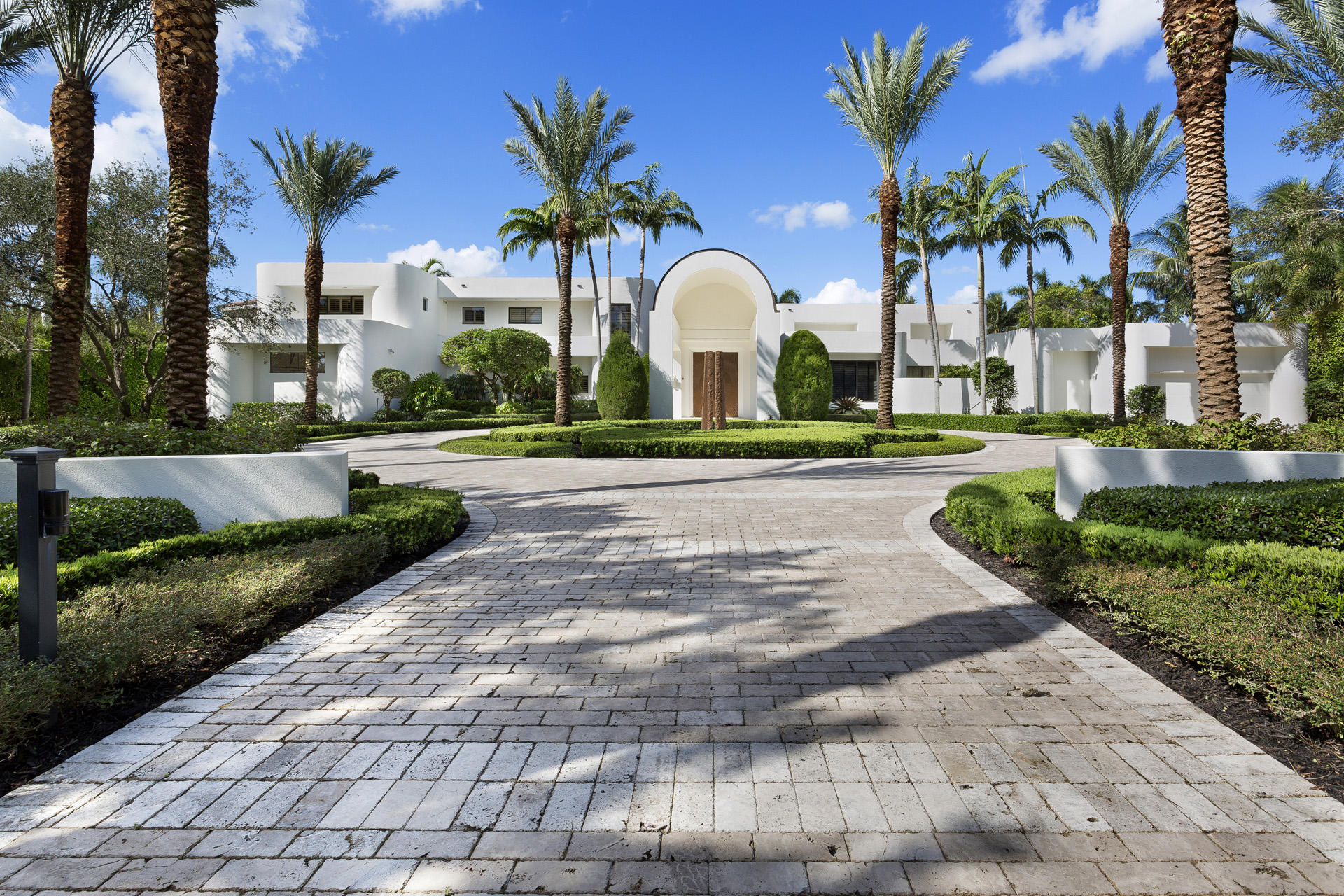 Facing west to a long stretch of waters, this   lakefront contemporary estate, reconstructed in 2007, is set back on sweeping 1.36±-acre grounds studded with tropical trees in lush seclusion.  Lakeside window walls open the residence to coral-stone terraces around the infinity-edge Pebble Tec pool encircling a spa.  The skylit lanai is served by a high-end summer kitchen. SUPPLIMENT
Disclaimer: The information provided herein including but not limited to prices, measurements, square footages, lot sizes, calculations and statistics have been obtained and conveyed from third parties such as the applicable Multiple Listing Service, public records as well as other sources. All information including that produced by the Sellers or Listing Company are subject to errors, omissions or changes without notice and should be independently verified by any prospect for the purchase of a Property. The Sellers and Listing Company expressly disclaim any warranty or representation regarding all enclosed information. Prospects' use of any information herein is acknowledgement of this disclaimer and that Prospect shall perform their own due diligence. Prospects shall not rely on this information when entering into a contract for sale and purchase. Some affiliations may not be applicable to certain geographic areas. If your property is currently listed, please do not consider this a solicitation. In the event a Buyer defaults, no commission will be paid to either Broker on the Deposits retained by the Seller. "No Commissions Paid until Title Passes." Buyer pays title insurance, Florida documentary stamps, and all other closing costs for New Construction and land use. Copyright 2016 Listing Company. All Rights Reserved.