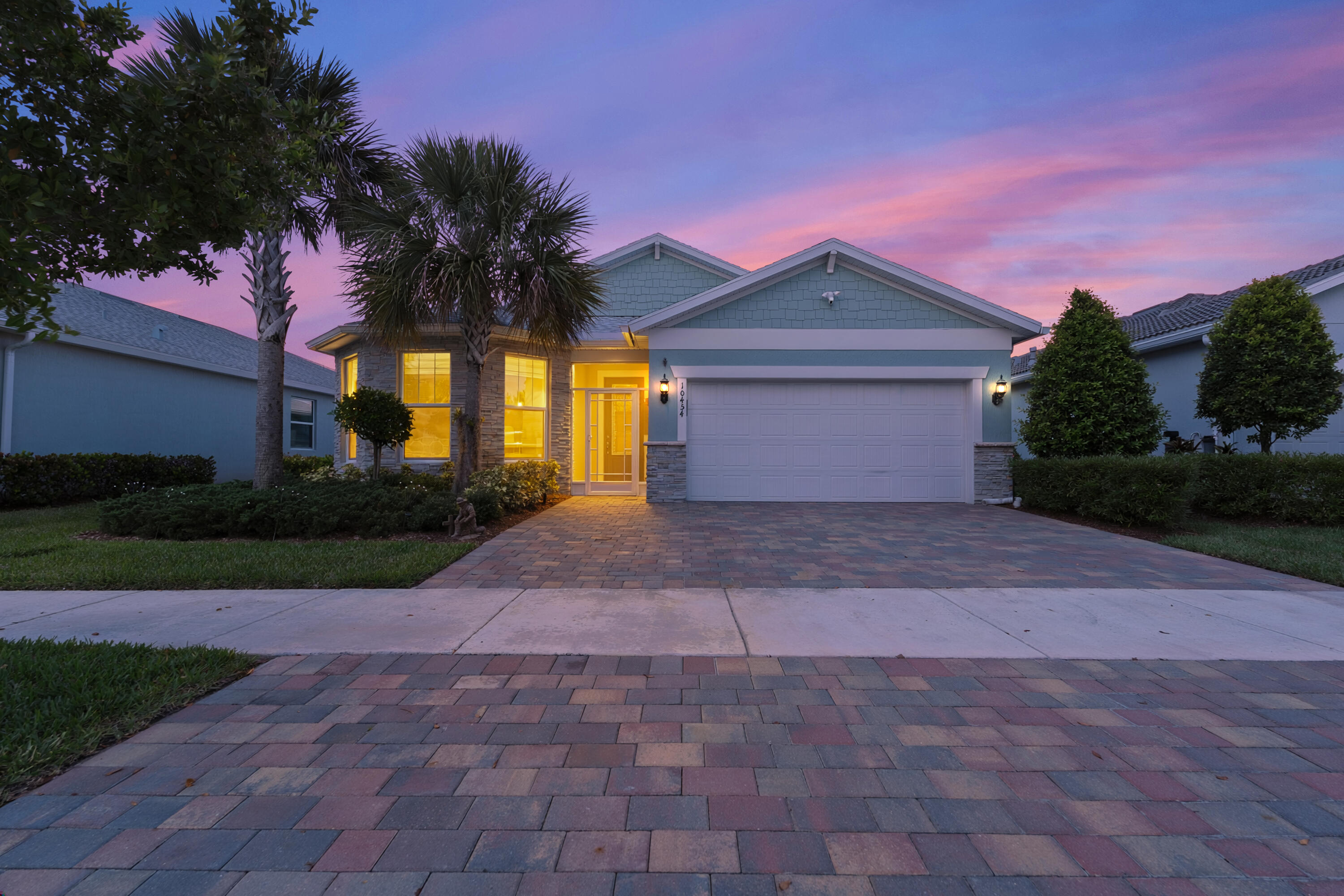 *WELCOME TO WATERFRONT LIVING IN HERON PRESERVE AT TRADITION* This impeccably maintained 3BR/2BA lakefront home offers breathtaking sunset views from a spacious covered lanai. Open-concept living showcases granite counters, white shaker cabinets, gas range, and oversized island. Owner's suite features water views, dual vanities, walk-in shower & custom closet. Premium upgrades: impact windows/doors, motorized shades, whole-home CAT6 wiring, SONOS sound, paver driveway & fenced yard. Enjoy golf cart living with a short walk to Stars & Stripes Park. Gated Heron Preserve offers a resort-style pool, & low HOA fees and NO CDD. Schedule your private showing today! All information, measurements, and details deemed reliable but not guaranteed; buyer to verify all during inspection period.