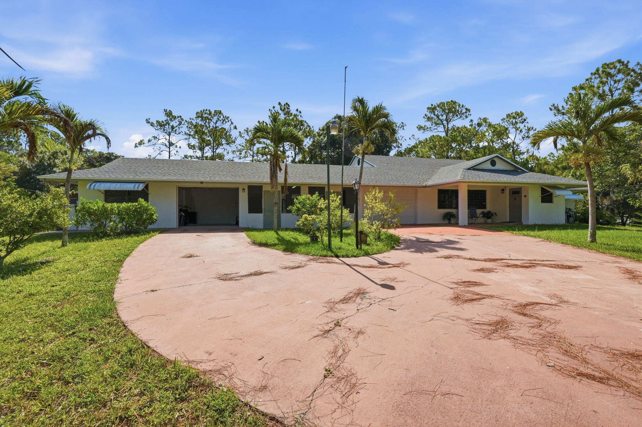 Ultimate  1.25 Acre Multi- General Compound or income- producing Estate! Rare opportunity to own a versatile, private family compound spanning 1.25 sprawling acres! This exceptional property features a spacious main residence perfect for central family living, seamlessly paired with multiple  studio apartments ready to be finished, whether you are looking to accommodate a multi-generational family, host long term guests, or generate substantial rental income, this estate offers unmatched flexibility. Each studio provides private entry and independent living space while remaining steps from the main home. Enjoy the peace and privacy of acreage living with plenty of room to expand, park recreational vehicles, or build a paradise backyard. This property has endless  potential. Structure is  built to with stand cat 4 hurricanes, the roof trusses are the maritime beams supporting the roof with 3 attics and two attic fans the home is insulated enough you don't need Ac but there is a brand new unit 2026, roof is 2025 special impact windows through out, 30 fruit trees , the property is also agriculture land where farming is governed by the green belt laws, plenty of room for small farm animals and the main house is built up high enough to never endure flooding, The small shed is also built up with a solid concrete foundation with triple insulation.