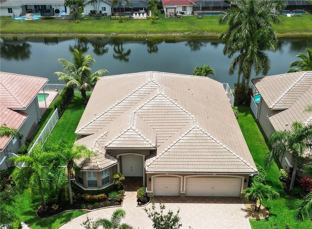 Stunning 3BD/3BA + Office in the exclusive Grand Reserve neighborhood! Guests will be impressed and you will have peace of mind with 24 hour guarded gate access. Your new open concept home has been meticulously cared for and well maintained with Plantation shutters, granite countertops, and NEW stainless steel appliances that adorn the kitchen. Enjoy the private heated pool, custom patio with travertine tile, and scenic waterview. There's even a large side yard with fencing. Access the community lake for kayaking in just steps. Features a 3-car garage with epoxy flooring, new water heater, and remote-controlled ceiling fans. Generator ready, smart home features include Nest smoke detectors, ecobee thermostat, Rainbird sprinkler system, and REME HALO air purification. Don't miss out! Immaculate 3BD/3BA + Office home in Coral Springs' desirable Grand Reserve neighborhood. This stunning residence boasts plantation shutters, granite countertops, and NEW stainless steel appliances in the kitchen. Enjoy the ultimate relaxation in your private heated pool, accompanied by a custom patio featuring beautiful travertine tile. Take in the serene waterview from the pool and patio areas. Rest easy knowing that the side yard fencing provides safety for kids and pets. The community lake is just steps away, offering convenient access for kayaking enthusiasts.Additional features include a spacious oversized office that can serve as an extra guest bedroom if needed. The home also showcases a 3-car garage with high-end epoxy flooring, a new water heater, and remote-controlled ceiling fans throughout, including the patio area. The property is generator ready, ensuring peace of mind during power outages. Smart home technology is incorporated with Nest smoke detectors, an ecobee thermostat, and a Rainbird wireless-controlled sprinkler system.Furthermore, the irrigation system utilizes water directly from the lake behind the home. The home also features a remarkable REME HALO Whole Home In-Duct Air Purification unit, providing an added layer of protection by eliminating up to 99% of viruses, bacteria, and mold. Don't miss the opportunity to make this your dream home. Schedule a viewing now!