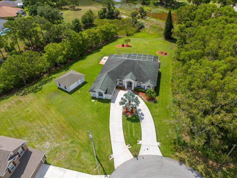 No HOA, on a Cul de sac, Detached Building on site - WHAT A VIEW!!!  Welcome to 6575 NW Pomona Court in desirable Port St. Lucie -- a beautifully maintained home nestled on a quiet cul-de-sac in a sought-after Northwest neighborhood. This inviting residence offers the perfect blend of comfort, functionality.  Step inside to discover a light-filled, open-concept layout featuring spacious living and dining areas ideal for both everyday living and entertaining. The kitchen boasts ample cabinetry, generous counter space, and a convenient breakfast bar overlooking the main living area. The split-bedroom floor plan provides privacy -  perfect for family or guests. Enjoy outdoor living in the private backyard with plenty of room to create your dream outdoor oasis.   The home offers a den/office that can be easily converted into a 4th bedroom.  Game room is large with 1/2 bath and access to the pool/patio.  Located just minutes from shopping, dining, parks, and major highways, this home offers both tranquility and convenience.