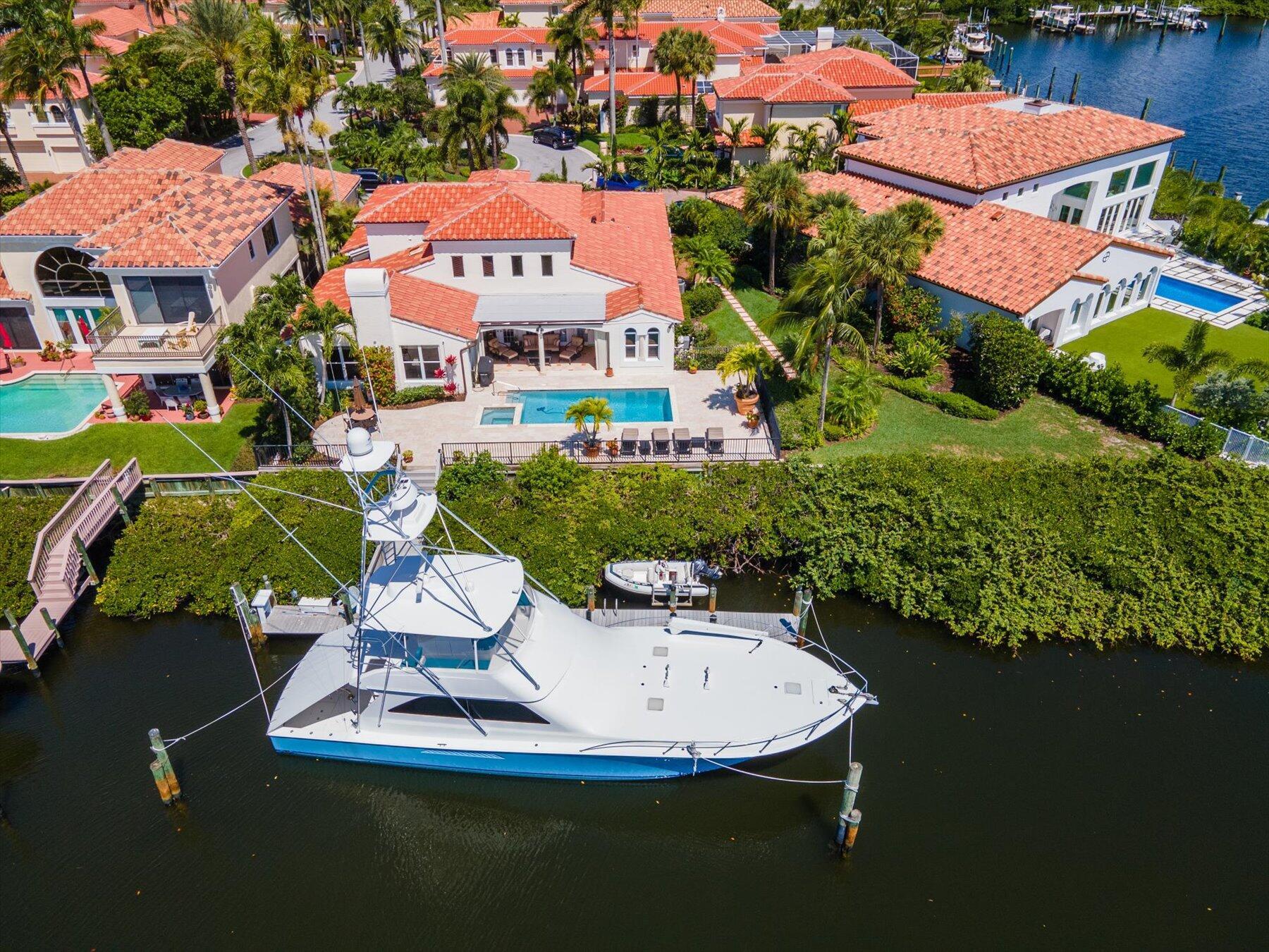This Waterfront ocean access home, with no fixed bridges, is located in the prestigious Jonathon's Landing Golf Club; which offers multiple levels of optional memberships alongside 3 award winning golf courses. Enjoy panoramic water views with almost 100ft of waterfront with a current dock that can support up to a 70ft vessel (+or- you can expand dockage to accompany a larger boat up to 100ft). Also enjoy a tender slip and boat lift as well. This home boasts many upgrades including 90% impact glass (2022), roof (2022), AC (2020), 2 water heaters (2020/13), resurfaced pool (2022), Refinished Pool Patio (2019), epoxy finished air conditioned 2 car + golf cart garage, with insulation for all car lovers (2020), high end bedroom carpet (2020), bathrooms (2019/2020). This home also boasts high end engineered hardwood flooring, solid wood doors, custom personal in-ground safe in master closet, custom wood plantation shutters, custom remote control/manual shades, complete custom drapery for each window. and ENDLESS opportunity to build up on the house, adding a second story and even more s/f. Nonetheless this home is in immaculate condition as it was mainly used as a seasonal home for the current owners.