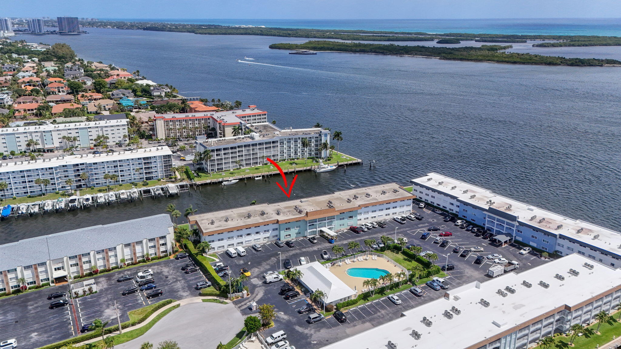 Enjoy direct water view of boats, fish, manatee, birds where the Earman River enters the Intracoastal Waterway! Solid CBS construction & accordion shutters make for easy storm preparations & security when travelling and/or seasonal lifestyle!  Extra storage closet on of the covered, screened porch. Generous room sizes! Updated and modernized 1 BR/1 bath. Gorgeous LVP flooring throughout 2024; kitchen 2025; bathroom 2024; A/C 2023 No carpet for better indoor air quality! Dedicated parking space #42 plus guest. Walk out to private fishing/sunning dock with 180 degree Intracoastal views from Old Port Cove to the Blue Heron bridge! Clubhouse offers a large heated pool and propane BBQ grill outside, tables, chairs and kitchen for gatherings plus a fitness center! No assessments! New roof 2022! Milestone & SIRS funded/completed in 2023 and any recommended repairs (some surface cracks being repaired, new paint after, both fully funded).  Budget fully funded per SIRS, high reserves!  No increase in COA fees in 2026. These comments reflect Building C association. Well run and funded!