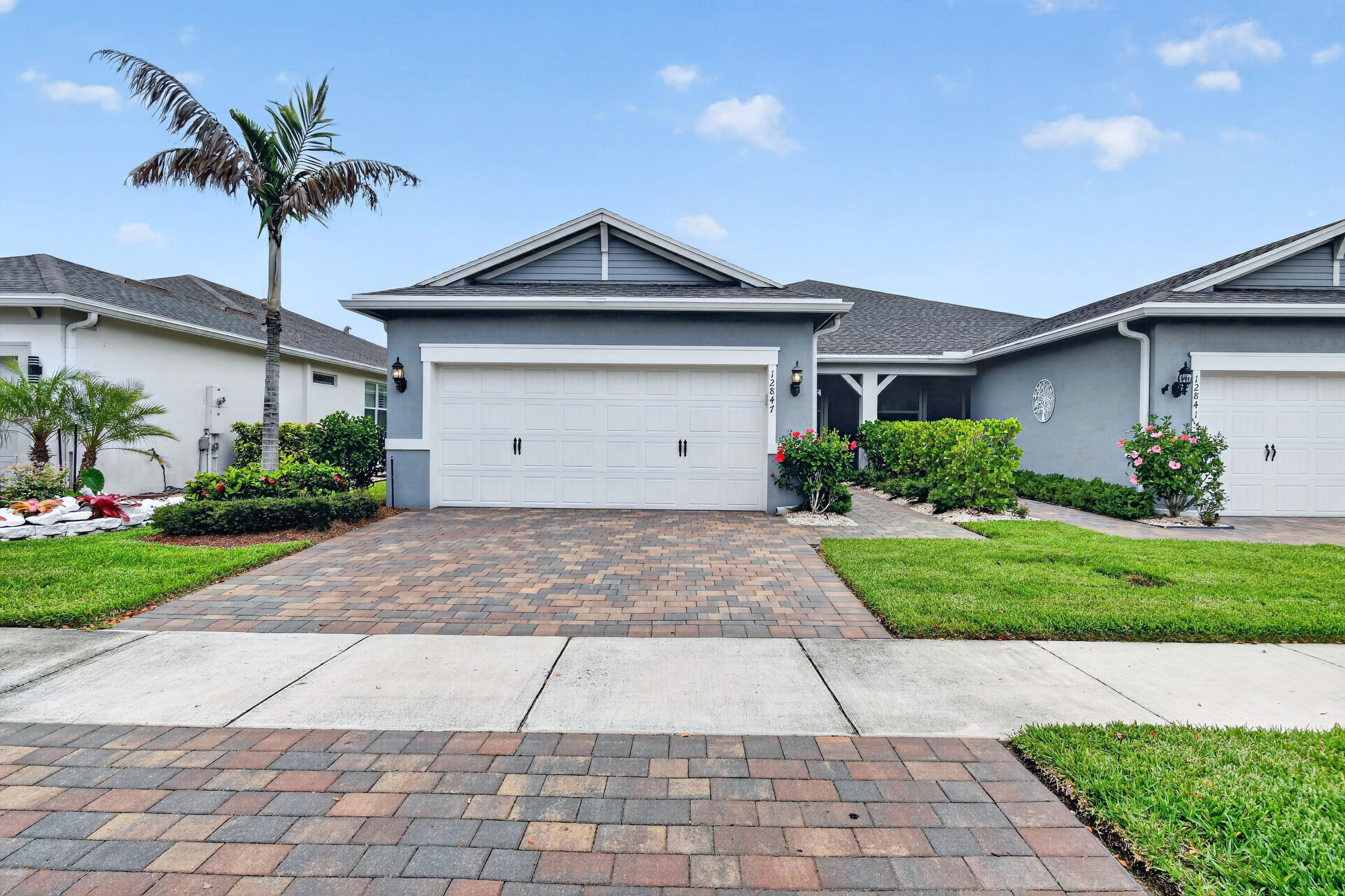 Welcome to this beautifully maintained 2 bed, 2 bath plus Den in Del Webb offering 1,579 sq ft of comfortable, modern living in the heart of Tradition. Built in 2022, this single-story residence features an open floorplan, a spacious eat in kitchen with white shaker cabinets and quartz counter tops, a pantry with custom shelving, and a foyer that sets the tone the moment you enter. Enjoy thoughtful upgrades including sink vanities, walk-in closets, ceramic tiles throughout villa, plantation shutters and storm windows. The living room overlooks the screened in back patio with beautiful pavers.   The home includes a 2 car garage and sits within a vibrant gated 55+ community with resort style amenities—clubhouse, fitness center, pool, pickleball, tennis, and more.   A perfect blend of convenience, style, and low maintenance living.