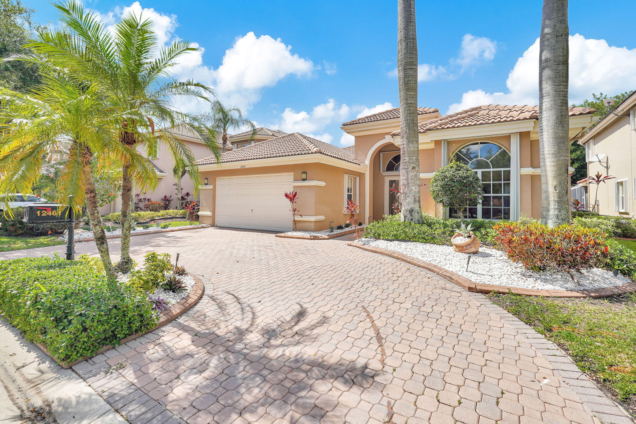 Indulge in luxury with this meticulously maintained, sprawling 1-story estate—exceptionally pristine and completely move-in ready! The expansive interior seamlessly blends elegant formal entertaining areas with an inviting family room, all anchored by gorgeous, flowing tile floors. A coveted split-bedroom layout ensures maximum privacy, showcasing a spectacular primary suite with a massive walk-in closet. Embrace idyllic outdoor living on the large, screened patio, framing serene, tranquil waterfront views. Nestled in a premier community with A-rated schools, this prime location offers effortless commuting near the main entrance, upscale shopping, and the Sawgrass Expressway. Best of all, you are just steps from the clubhouse, pool, tennis, and pickleball! Priced to sell.