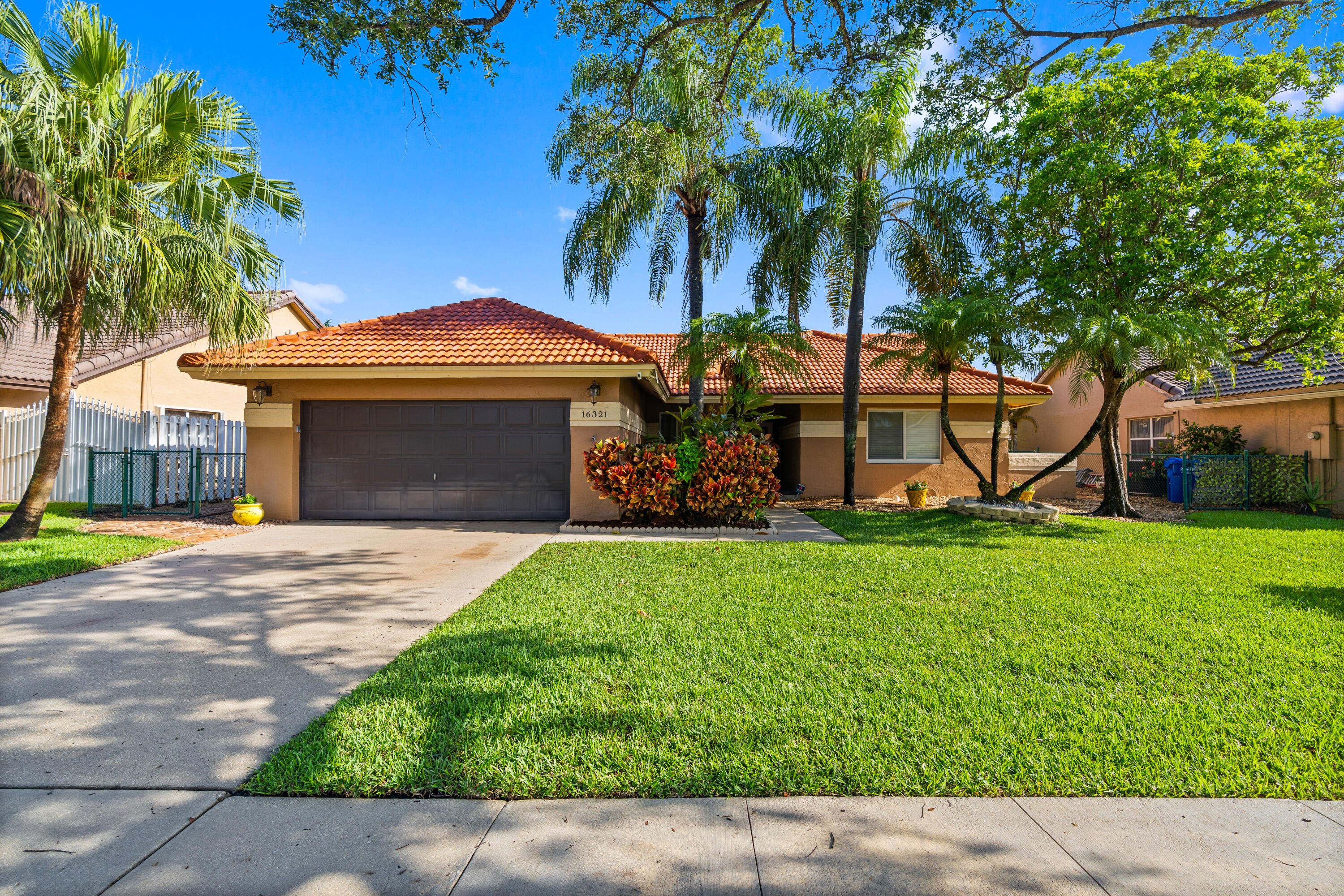 This charming one-story home features a spacious open floor plan that offers comfortable living and great natural light throughout. The property has several important upgrades, including a new roof installed in 2018 and impact windows installed in 2025, providing peace of mind and energy efficiency. The home is equipped with a thankless water heater for continuous hot water and modern convenience. Step outside to enjoy a beautiful, oversized backyard with a tranquil lake view, perfect for relaxing or entertaining. The backyard also features a Jacuzzi, creating the ideal space to unwind and enjoy the outdoors.