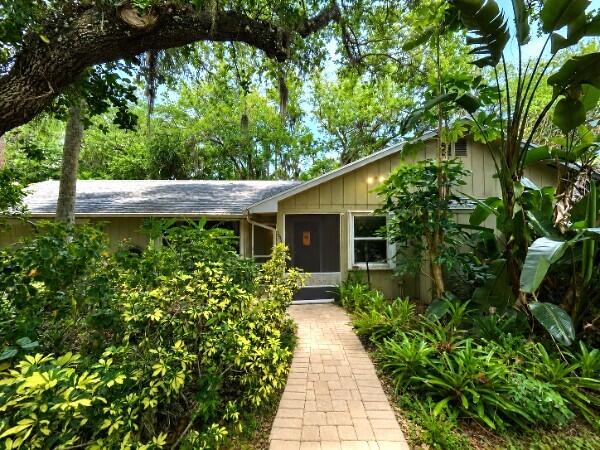 Nestled just off SW Salerno Road in the heart of Stuart, this well-maintained 3-BED/2-BATH single-family home offers the perfect blend of comfort, space, and privacy on an expansive ~1/3 acre FULLY FENCED lot. Step inside this SINGLE STORY home to find a functional layout featuring a spacious master suite with private EN-SUITE BATH & LARGE WALK-IN CLOSET while the main living areas showcase durable tile flooring throughout and carpeted bedrooms for added comfort. All appliances convey with the sale, WASHER & DRYER INCLUDED, water softener, and reverse osmosis FILTRATION SYSTEM. Enjoy true Florida living with a screened front enclosure along with a LARGE COVERED REAR PATIO perfect for entertaining or unwinding while overlooking the peaceful backyard.  The property is surrounded by mature tropical landscaping, offering both shade and a sense of seclusion. This property stands out with exceptional outdoor utility, including TWO OVERSIZED SHEDS for storage, hobbies, or workspace, plus a one-car garage and an additional carport for FLEXIBLE PARKING or covered storage. Located in a quiet, established area just minutes from shopping, dining, and coastal amenities, this home offers a rare combination of space, functionality, and tranquility in one of Stuart's most desirable corridors.