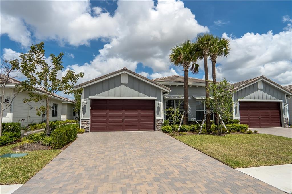 This MODEL like home with den is located in the gated community of Arden. Built in 2021, this move-in ready home shows like a model. The open floorplan extends from the kitchen and eating area to the large living room. Step out to the screened-in patio that overlooks the peaceful lush greenery. Kitchen with large island features upgraded cabinets and quartz countertops. Generous sized master suite has 2 walk-in closets and en-suite with step-in shower, separate water closet and dual sink vanity. Split bedroom plan offers privacy with 2 guest bedrooms and bathroom with tub/shower. Other features of the home are ceiling fans, wood look ceramic tile, and inside laundry.  Feel like your on permanent vacation with the resort style amenities of this sought-after community.