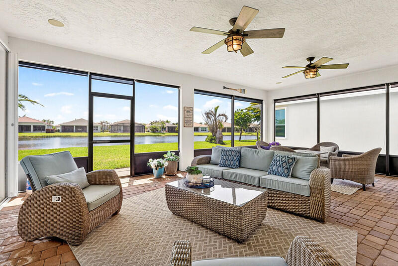 Enjoy the resort style living in this 55+ gated community of Vitalia in Tradition. You will love the view from extended Screened Porch of this beautiful Lakefront home! This CBS 2 Bedroom+Den home is immaculate. Upon entering the home you will see beautiful tile floors throughout the living areas. The kitchen features granite counter tops, stainless steel appliances with gas range and large island! The Master Bedroom is open and spacious with two walk-in closets, crown molding and lake view! The master bath has double sinks and shower! This home is a must see for anyone wanting to be in Vitalia. Enjoy Vitalia's 24,000 s.f. clubhouse with resort pool and spa. Other amenities include tennis, pickleball, bocce, putting green, billiards, darts, card rooms, and grand ballroom. Upgrades worth mentioning are 1. New Microwave and Refrigerator. 2. Exterior was repainted and new screens in back patio along with sunshades. 3. New Hot water heater. 4. New LPV flooring in bedrooms and den. 5. New quartz countertops in master bath and 2nd bedroom. 6.Attic has insulation foam that was added. 7. New washer and dryer.