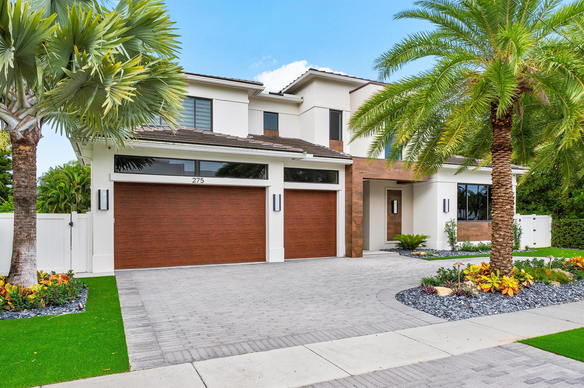 Nestled within the prestigious enclave of Boca Villas, mere moments from Mizner Park, this expansive 4,300 square foot residence, meticulously constructed by Alpha Premium Development, has been elevated to epitomize unparalleled refinement. The home's expansive open floor plan seamlessly integrates both formal and casual living spaces, with a central dining area adorned by a bespoke wine bar, fostering an ambiance of grandeur and welcoming ease. A thoughtfully placed first-floor bedroom, complete with a private bath and closet, serves as an ideal office or guest suite.
Ascending the staircase, a luxurious media loft awaits, along with four generously proportioned king-size ensuite bedrooms, each boasting a private bath and built-in closets. The primary suite, a sanctuary of tranquility, features full-height custom closets, a spa-inspired bathroom, and automated shades.
 
Step onto the expansive plank porcelain patio, where a Wolf/Sub-Zero outdoor kitchen, soaring wood ceilings, and exquisite fixtures create an idyllic setting for alfresco entertaining, overlooking a lush, turfed backyard and a shimmering saltwater pool.
 
Available furnished (not included)  with nearly new designer pieces, this residence invites immediate enjoyment. Paradise, indeed, awaits.