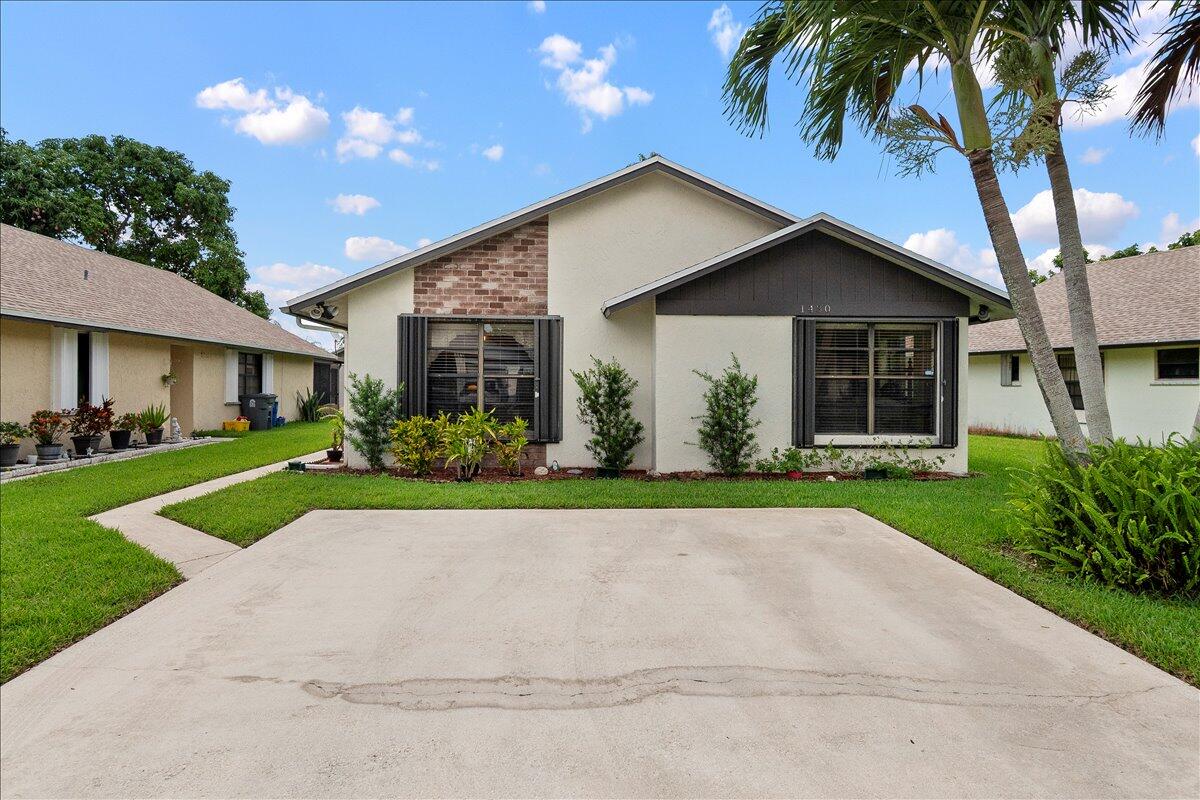 This beautifully maintained 3-bedroom, 2-bath residence features a desirable split-bedroom floor plan and soaring vaulted ceiling that creates an open & inviting living space. Perfectly situated in the heart of West Palm Beach, you'll enjoy convenient access to shopping, dining, schools, parks - everyday essentials are just minutes away. A new roof was installed in 2024, providing peace of mind for years to come. Step outside onto the spacious covered and screened patio, an ideal setting for morning coffee, grilling, or entertaining family & friends year-round.  The low HOA fee of just $170 per month includes lawn maintenance, allowing you to enjoy a well-kept property with less upkeep. Ask the listing agent about the 10K lender credit - it's like FREE money!