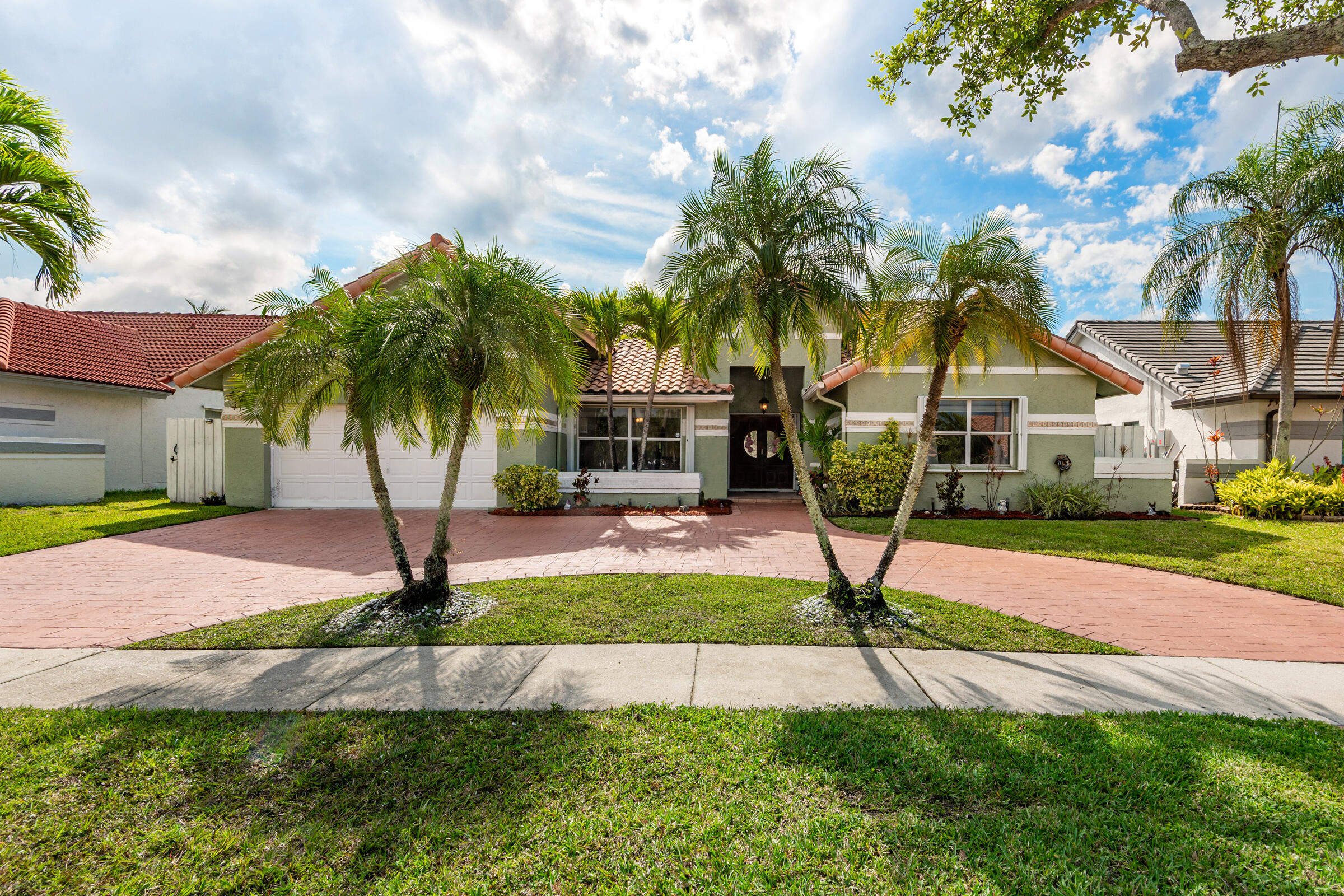 Pride of ownership shines throughout this beautifully maintained Diamond model in the heart of Pembroke Pines' desirable Spring Valley community. This home features spacious living areas, granite countertops, elegant crown moulding, and a stamped concrete circular driveway and patio. Enjoy peace of mind with accordion storm shutters, a generator, 2 years washer and dryer. 4 years  A/C and 5 years water heater. Relax in your backyard oasis with tranquil water views and fishing right at home. Conveniently located just minutes from major highways and shopping. This home shows like a model!