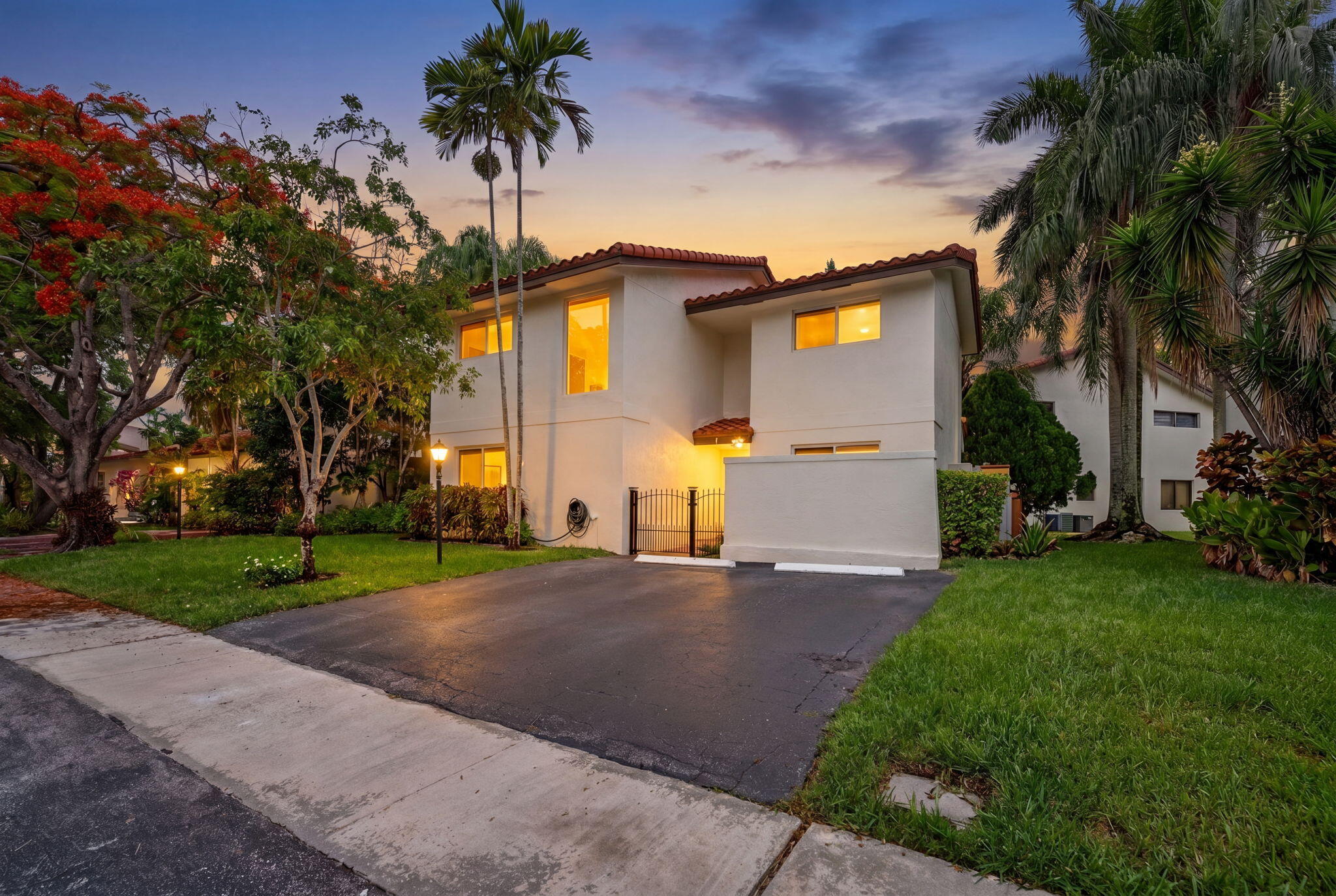 Nestled within the exclusive 26-home community of Cocoranda in the heart of Jacaranda Golf & Country club, this beautifully maintained single-family residence (one of only two single family homes in the community), offers the perfect blend of comfort, style, and location.  Just a short walk from two award-winning, impeccably maintained 18-hole golf courses, this home is ideal for golf enthusiasts, first time home buyers, and those seeking a tranquil South Florida lifestyle.  Recent upgrades provide peace of mind, including FULL IMPACT WINDOWS AND DOORS, A NEW ROOF (2025), REMODELED UPSTAIRS BATHROOMS (2025), FRESH EXTERIOR PAINT (2025), AND TWO ZONED A/C SYSTEMS (2025 & 2012).   The spacious floor plan features a welcoming living room, formal dining room, and a comfortable family room adjacent to the kitchen.  Both the living room and family room open seamlessly to the outdoor living area, creating an ideal setting for entertaining or relaxing year-round.  Residents enjoy a low monthly HOA fee that includes lawn maintenance, community common areas, and access to the neighborhood swimming pool, allowing for easy, low-maintenance living in one of Jacaranda's most desirable communities.  MOVE IN READY and thoughtfully updated, this home offers exceptional value in a premier golf course setting.