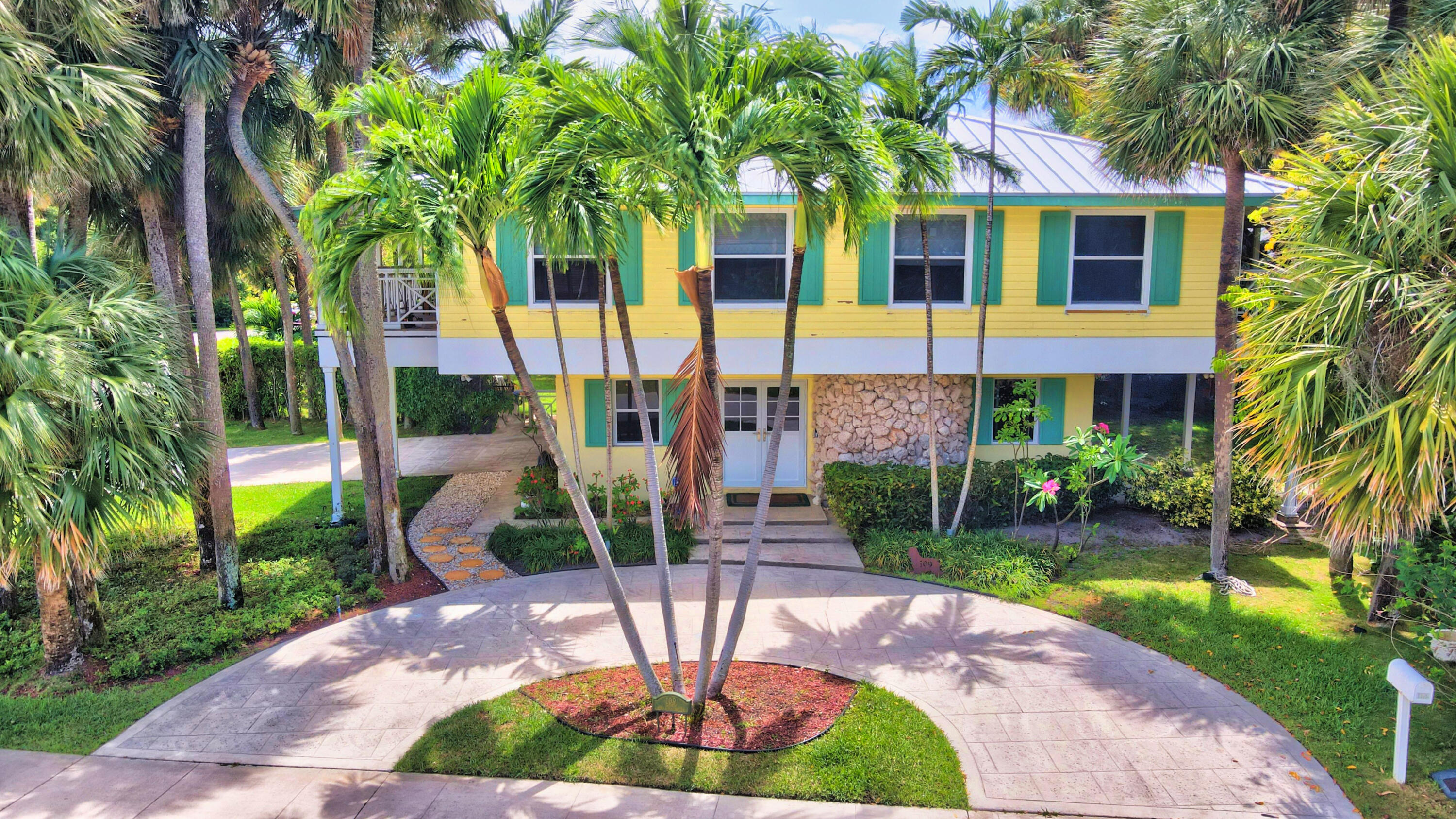 ONE OF A KIND-Fully updated and ready to move in Key West Style home in the highly sought after, boutique beachside neighborhood of Por La Mar.  This charming home is located on a double lot, and the possibilities are endless! Home was renovated in 2019 and includes an open floorplan with porcelain tile wood floors throughout. A gorgeous cook's kitchen with Bosch appliances, Island and large side-by-side refrigerator /freezer makes entertaining a breeze.   Main living area and 3 bedrooms are on the 2nd floor with full length balconies on the north and south sides.  Primary bedroom has a spa bath, with separate tub and shower.  Downstairs includes a full guest suite with bonus room for exercise, additional office, etc.    The side yard is a private oasis for this house, or can be separated developed as a full lot.  All windows and doors are impact, and the Metal roof was also replaced in 2019. The front of this house looks onto a private park which is the center of Por La Mar, with huge Ficus and Banyan trees.  Por La Mar is a Hidden enclave of luxury homes  only steps to the beach, the new Intracoastal waterfront park, and all the shops and restaurants of downtown Boca Raton.  There is nothing else like this so close to the beach.