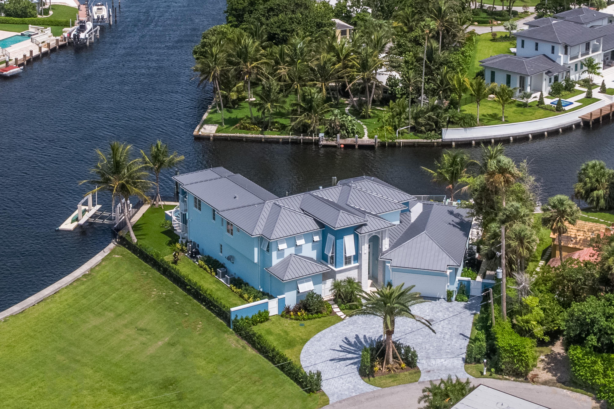 This recently built, custom home in Ocean Ridge reigns over a whopping 190' of water frontage on a secluded point lot. The home comes equipped with every luxury appointment that even the most discriminating Buyer can not ignore! This is a luxurious ''Smart'' home with state-of-the-art technology has 6 bedrooms and 5.5 baths.  It features all the conveniences and upscale amenities you expect in an exquisite residence. You'll love the open floor plan which includes a media room and large playroom, custom fireplace and wet bar for easy entertaining. The gorgeous gourmet kitchen provides a center island area for prep, fabulous counter space, top of the line stainless steel appliances and custom cabinetry for storage. There are two master suites, one on each level with an elevator to take you between the upper and lower levels


Water views are yours throughout the home, and the family amenities include a resort style pool, hot tubs, fire urns, and beautiful sunset views over the water.
If boating and water sports are your passions, this home offers deep water dockage for boats up to 70' with ocean access just a 1/2 mile trip to the Boynton Beach Inlet. It all adds up to the perfect getaway for a life of luxury living along the waters of the Intracoastal.
 
You may also enjoy taking your paddle board out to enjoy the early morning birds along the Intracoastal, or if you prefer the fast lane, jump into a kayak and enjoy the quiet journey at your own speed. Either way, you can always find something of interest and fun to do on the water just outside your door. For beach lovers, you'll have direct access to the warm sand and water located just across the street from your home.
 
In addition to living in the quiet, secure, upscale community of Ocean Ridge, other amenities include a 2+ car garage with a custom gym that includes monkey bars and rings for your private workouts. World class fine dining and shopping is available in nearby Boca Raton and along Worth Avenue in prestigious Palm Beach, and the Palm Beach International Airport is just a short drive from your luxury home.