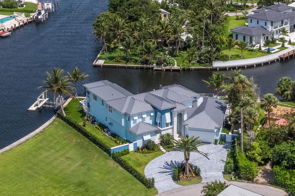 This recently built, custom home in Ocean Ridge reigns over a whopping 190' of water frontage on a secluded point lot. The home comes equipped with every luxury appointment that even the most discriminating Buyer can not ignore! This is a luxurious ''Smart'' home with state-of-the-art technology has 6 bedrooms and 5.5 baths.  It features all the conveniences and upscale amenities you expect in an exquisite residence. You'll love the open floor plan which includes a media room and large playroom, custom fireplace and wet bar for easy entertaining. The gorgeous gourmet kitchen provides a center island area for prep, fabulous counter space, top of the line stainless steel appliances and custom cabinetry for storage. There are two master suites, one on each level with an elevator to take you between the upper and lower levels


Water views are yours throughout the home, and the family amenities include a resort style pool, hot tubs, fire urns, and beautiful sunset views over the water.
If boating and water sports are your passions, this home offers deep water dockage for boats up to 70' with ocean access just a 1/2 mile trip to the Boynton Beach Inlet. It all adds up to the perfect getaway for a life of luxury living along the waters of the Intracoastal.
 
You may also enjoy taking your paddle board out to enjoy the early morning birds along the Intracoastal, or if you prefer the fast lane, jump into a kayak and enjoy the quiet journey at your own speed. Either way, you can always find something of interest and fun to do on the water just outside your door. For beach lovers, you'll have direct access to the warm sand and water located just across the street from your home.
 
In addition to living in the quiet, secure, upscale community of Ocean Ridge, other amenities include a 2+ car garage with a custom gym that includes monkey bars and rings for your private workouts. World class fine dining and shopping is available in nearby Boca Raton and along Worth Avenue in prestigious Palm Beach, and the Palm Beach International Airport is just a short drive from your luxury home.