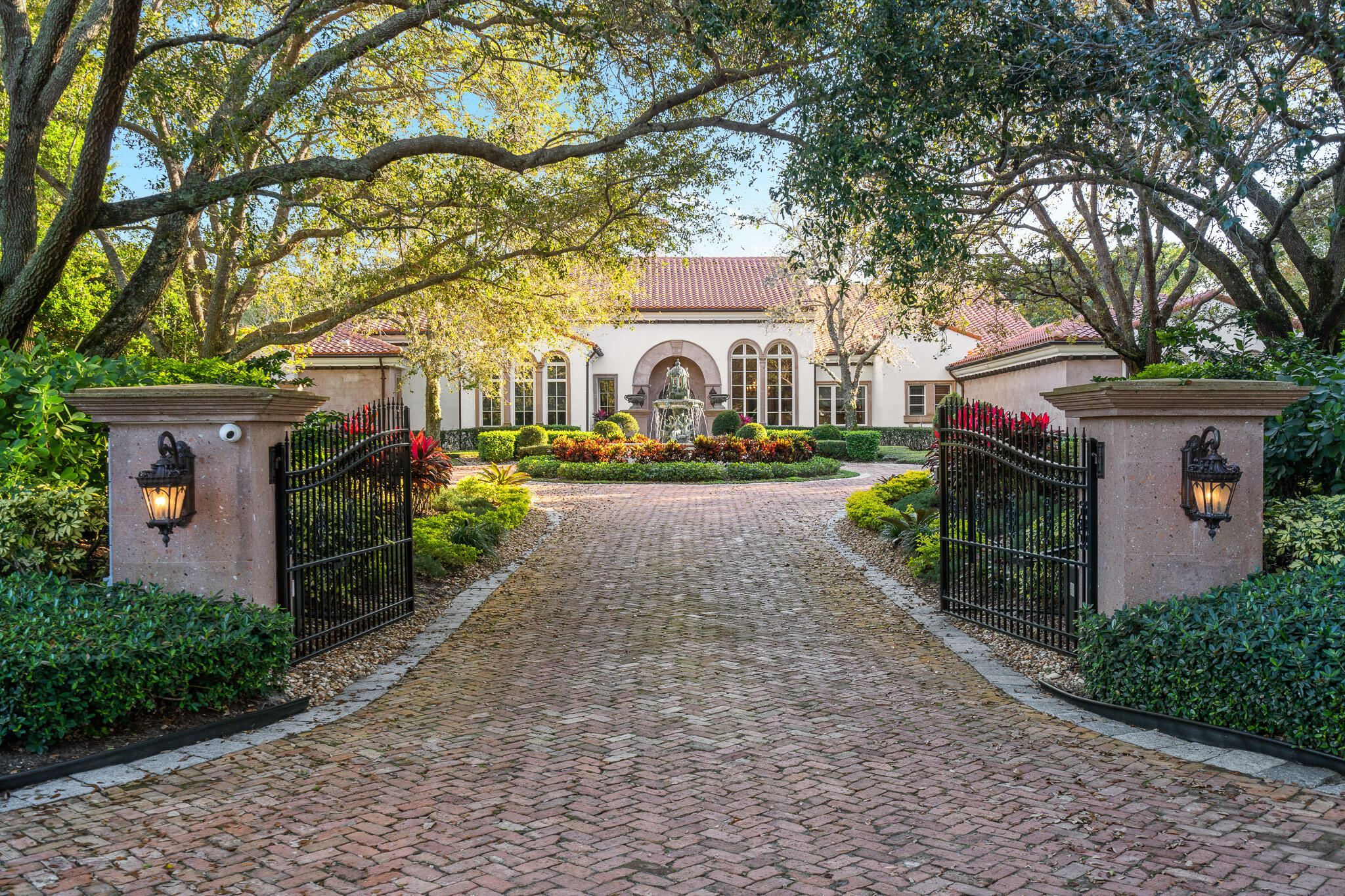 This one-story classic ''Montecito Style'' residence is located on 2.13 acres of meticulously manicured grounds within Boca Raton's most prestigious & intimate gated enclave of only 32 multi-acre estates. Designed by award winning architect Randall Stofft, this exquisite lakefront estate seamlessly blends an indoor/outdoor vibe with traditional elements, warmth & cohesiveness & features a stunning lushly landscaped gated entry with circular driveway & stone fountain. This home offers 5 bedrooms, 6.1 bathrooms, office/library, media room/den, playroom & side-load air conditioned 4 car garage.  The luxurious & grand outdoor space is full of amenities & features designed for intimate family gatherings as well as elegant & sophisticated entertaining. Included is a large patio with multiple covered loggias, outdoor summer kitchen & entertainment area, fireplace, oversized pool & walking path leading to dock with electric pontoon boat. Other features include impact windows & doors & a full house generator. Le Lac features 70 acres of spectacular lakes allowing motor boats & water sports.