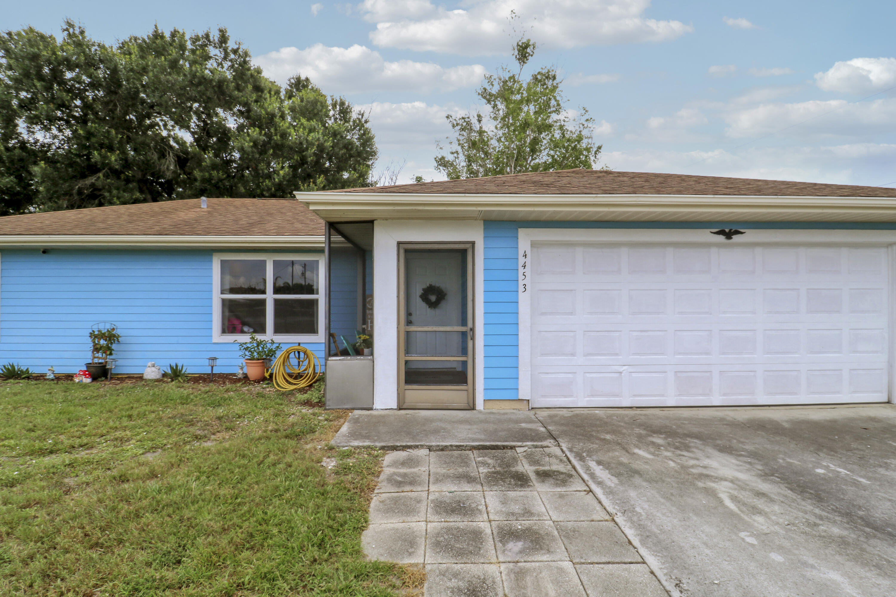 Move-in ready and packed with valuable upgrades, this 3-bedroom, 2-bath, 2 car garage home in Port St. Lucie sits on a large fenced corner lot with no HOA and features major improvements like: complete Impact glass windows, a brand-new GE electrical panel (2025), a new pre-wire for a generator, 2020 HVAC, and a 2022 water heater.  Inside, you'll find tile flooring throughout, vaulted ceilings and a split plan layout designed for comfortable everyday living. The kitchen features granite countertops, a matching granite backsplash, oak cabinetry, and Frigidaire Stainless Steel appliances. The new washer and dryer (still under warranty) can remain for the new owners. Walk-in closets provide ample storage, the bathrooms have been updated, and the home has been well maintained. Step outside to enjoy the expansive 0.27-acre fully fenced backyard, offering many options for entertaining, gardening, pets, or simply relaxing in your own private screened lanai. An irrigation well for the sprinkler system helps keep utility costs down. Located just minutes from parks, shopping, dining, and the popular Tradition area, this property combines affordability, functionality, and desirable upgrades in one exceptional package. With no HOA restrictions and room to spread out, this home is ready for its next owner to move in and enjoy.
