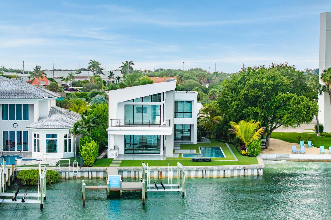 This breathtaking modern estate, built in 2022 by Rothrock Construction, boasts 180 feet of Intracoastal frontage with stunning blue-water views. Situated on a private 0.5-acre lot with no HOA, it offers sleek architecture, expansive glass walls, soaring ceilings, and high-end finishes. The open-concept design features a gourmet kitchen with a gas stove, while a separate guest house provides additional privacy for visitors. The Seller has upgraded all the landscaping for enhanced beauty and seclusion, adding premium artificial turf throughout the backyard for a lush, low-maintenance appeal. The fire pit has been upgraded to a sleek linear design, perfect for entertaining or relaxing. Priced to sell, this waterfront masterpiece is a rare opportunity! The property includes a Neptune boat lift, seawall built in 2022 and deep-water dock, making it a boater's paradise with direct Intracoastal access.

Property Highlights:

" 180 feet of Intracoastal frontage
" Neptune boat lift and deep-water access
" Open-concept design with expansive water views
" No HOA
" Full-house generator
" Gas stove in a modern kitchen
" Separate guest house
" Backyard fully landscaped with turf

This stunning estate seamlessly blends modern elegance, coastal tranquility, and top-of-the-line features.