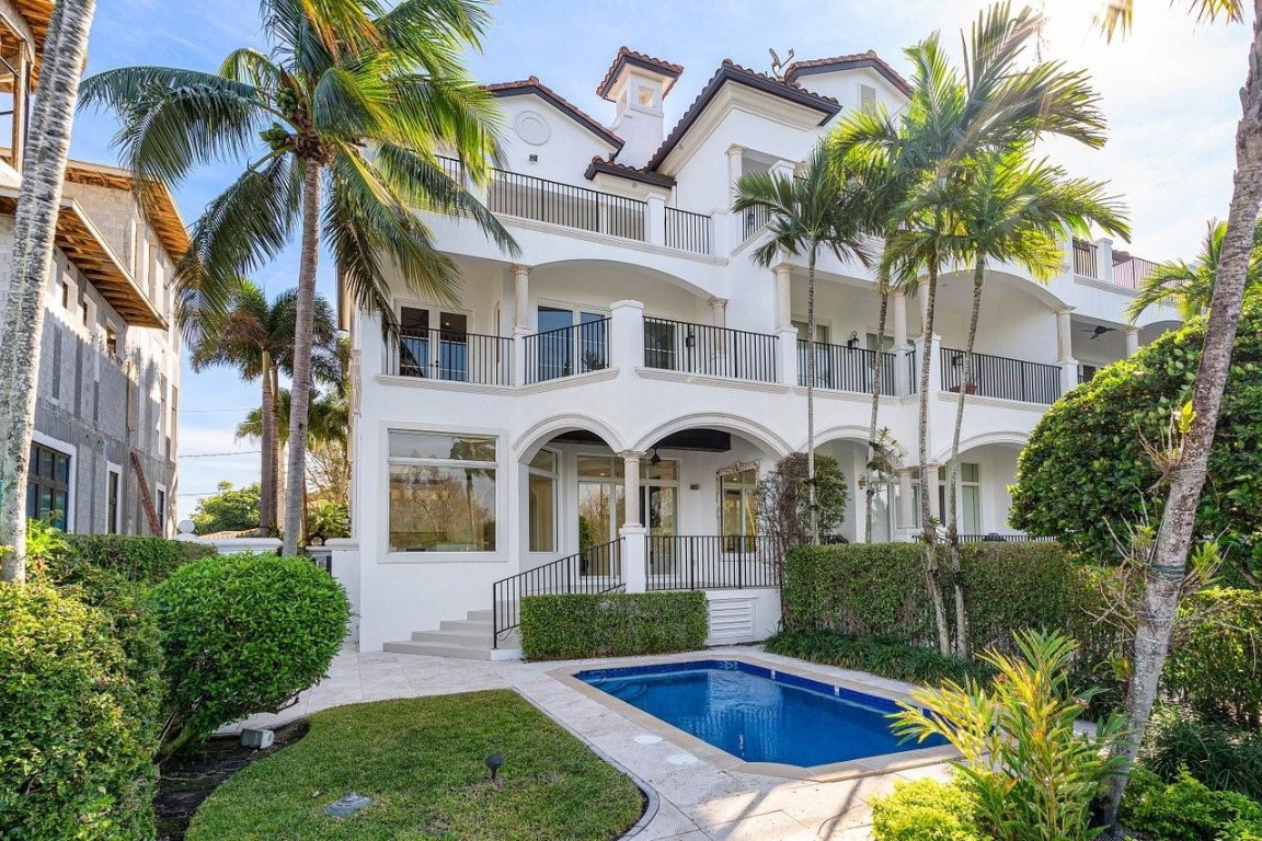 Experience luxury coastal living in this elegant 3-story townhouse on The Island, positioned along the Intracoastal Waterway and mere steps from iconic Deerfield Beach. This end-unit offers 3 ensuite bedrooms with private balconies, a personal study off the primary suite, and a great-room that showcases sweeping views of the Deerfield Island Preserve. Highlights include soaring custom ceilings, stunning gourmet kitchen, Lutron LED lighting system, and a 3-stop elevator. Outside, enjoy a spacious lanai, private heated pool, dock w/boat lift, standby generator, and a 2-bay garage with a lift for a 3rd vehicle. Enjoy the charm of nearby beachfront eateries on this scenic barrier island, with the added convenience of being just minutes from vibrant downtown Boca Raton and the executive airport