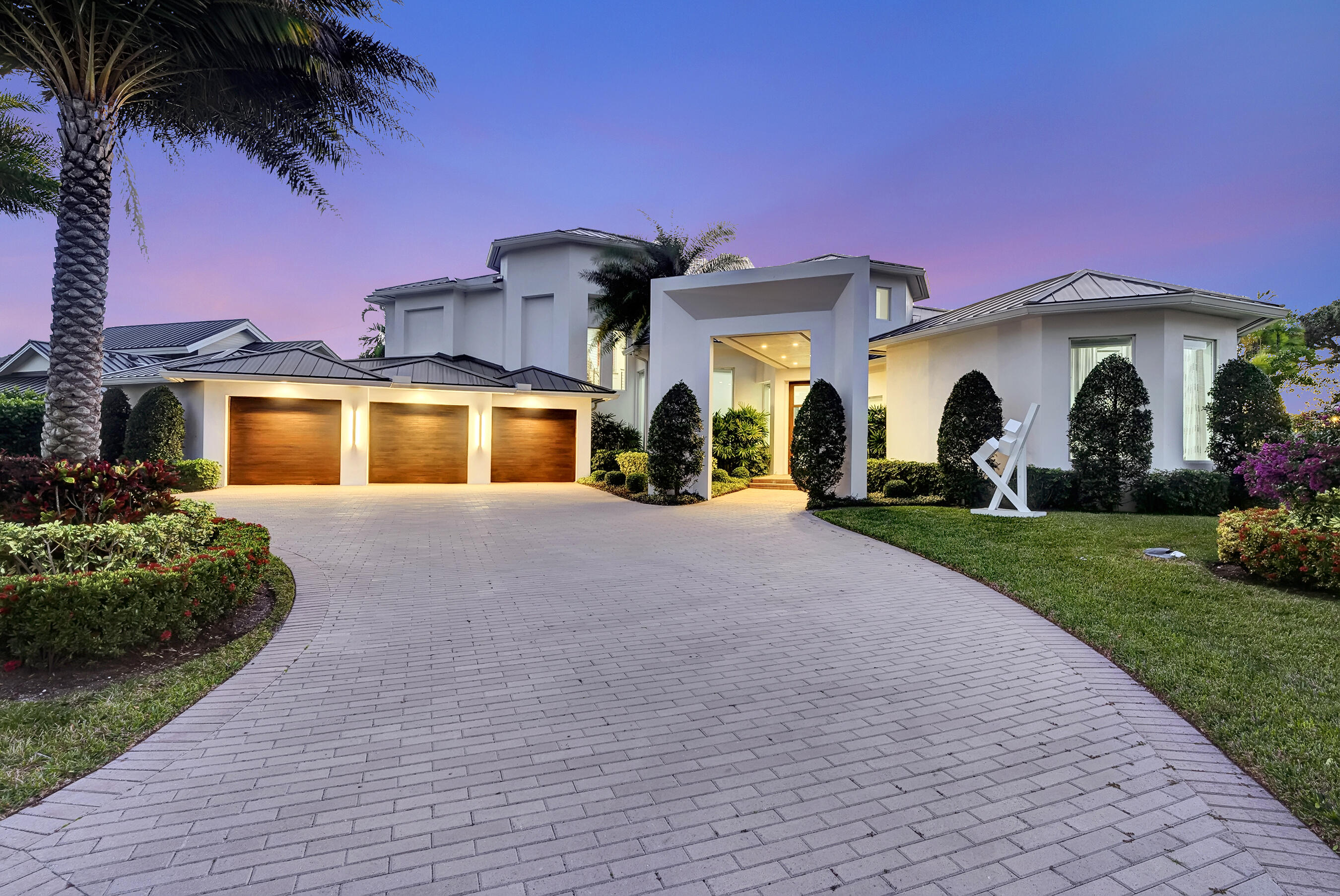 Stunning panoramic lake and golf course views await you the moment you step through the doors of this newly renovated and redesigned estate. Ideally situated on one of the most spectacular lots in any Palm Beach County Country Club, and designed by renowned architect,  Elmar Benavente, this beautifully crafted estate home was renovated with impeccable taste, style and workmanship. This contemporary two-story home features five bedrooms, six full bathrooms, and one half bath, providing plenty of room for you and your guests to spread out, relax and enjoy the stunning  lake and golf course views from almost every room. Luxury and elegance define a spacious open floor plan featuring dramatic high ceilings, a magnificent bar, perfectly designed for entertaining, a gourmet kitchen featuring an oversized island, quartz countertops, sleek lacquer cabinetry, top-of-the-line appliances, including double ovens, microwave drawer, and a multi-adjustable burner Thermador induction cooktop. The kitchen flows seamlessly into the spacious dining room, and family room/den, which is prewired for media and sound. The luxurious master suite will captivate you with its high ceilings, enormous bathrooms and closets, beautiful fixtures, large glass enclosed showers and a designer soaking tub. There is also a large first floor guest suite with a walk-in-closet, and a first floor office. Upstairs, guests have three bedrooms and baths, their own comfortable TV loft sitting area and balconies with extensive views of the lake, wildlife and golf course. Experience the best of indoor-outdoor living on the gorgeous lanai which features electric screen shades, spacious dining and seating areas, just off the beautiful large pool which is surrounded by a tropical paradise of lush palms and privacy landscaping. Whether you're hosting a pool party or simply enjoying the serenity of just floating around your own private island, this outdoor oasis is sure to become your favorite spot. Even if you're not a wildlife enthusiast, you can't help but smile at the line ducklings following their mother duck around the lake, or the beautiful blue herons perched on the hill, or the loons spreading their wings in the sun. And as the day dims and evening approaches you will be awestruck by the beauty of the incredible sunsets from this gorgeous west facing home. Delaire Country Club is not just a residence, but a private boutique country club, where 324 custom homes surround a 27-hole championship golf course that requires no tee time. The clubhouse itself is a work of art, featuring a state-of-the-art 16,000 sq ft fitness center, outstanding culinary cuisine, a resort-style pool area, and 8 Har-Tru tennis courts. Enjoy the generous extended family policy that Delaire offers, ensuring that you and your loved ones can fully embrace the country club lifestyle.