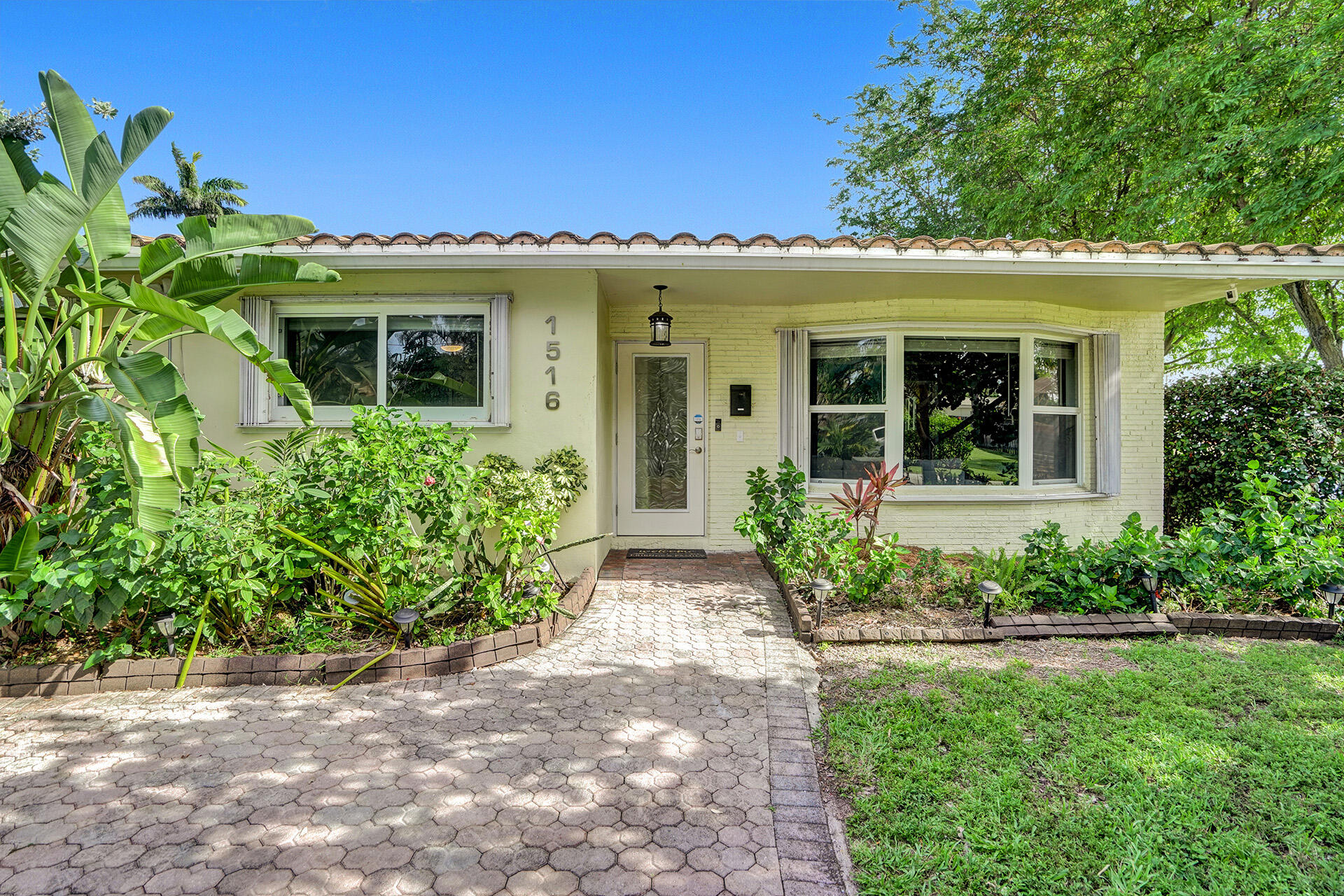 This modern 4-bed, 2-bath residence is situated on a quiet corner lot. This beautifully decorated furnished home has an open-concept floor plan. The expansive living, dining, and kitchen areas are highlighted by a large quartz kitchen island with a view of the pool. Notable interior amenities include custom closets, & hurricane-impact windows/doors. Exterior features include a charming circular driveway in the front & a large driveway with attached 1 car garage in the rear. French doors provide access to a covered patio & cabana bath equipped with a child-safety door alarm. The property also offers a sparkling heated pool & spa combo, featuring a new heater with an adjustable temperature and shut-off control panel. Additional upgrades include a newer HVAC system, exterior security cameras, and a spacious, fenced-in backyard with "Trex" decking. The property was approved by city inspection for use as a vacation or short-term rental.