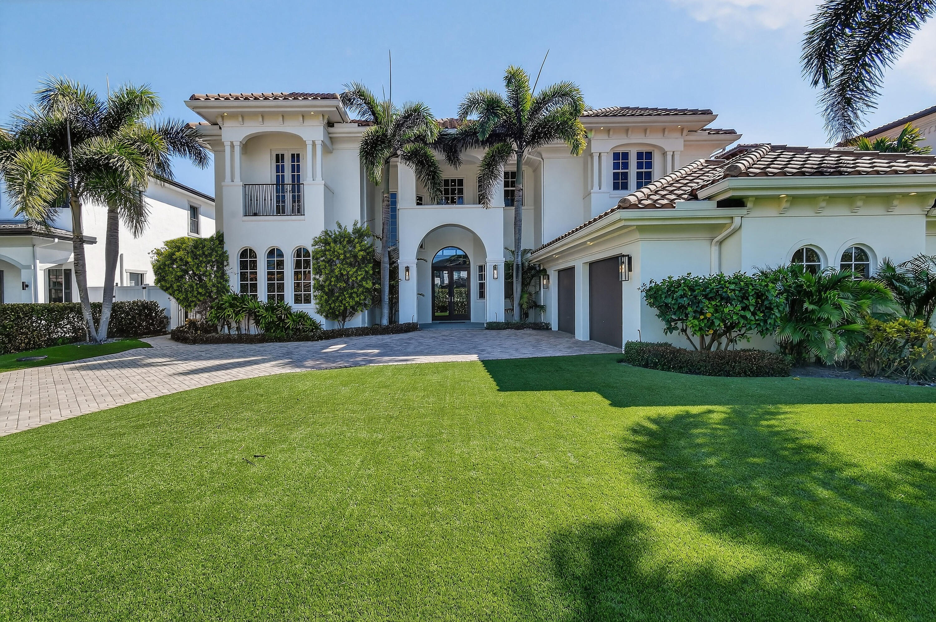 Tucked along a peaceful waterfront in Palm Beach Gardens, 12860 Inshore Drive captures the essence of refined coastal living, where mornings begin on the water and evenings are spent entertaining under the palms. With effortless access to the Intracoastal and the open ocean, boating becomes a natural extension of daily life, while the absence of HOA fees offers a rare sense of freedom and privacy. Inside, the home is beautifully curated for comfort and sophistication. A private first-floor office offers a quiet retreat for work or study, while the primary suite is designed as a true sanctuary with dual bathrooms, expansive walk-in closets, and a dedicated fitness area. Marble flooring, impact glass, and smart home technology elevate both the aesthetic and functionality of the residence. The upper level provides gracious accommodations for family and guests with two ensuite bedrooms, an additional bedroom, and a versatile loft ideal for a lounge or media space. Outside, the setting feels like a private resort, with a heated saltwater pool and spa framed by lush tropical landscaping. The outdoor kitchen, featuring stainless steel cabinetry, a gas grill, cocktail station, and refrigerator, invites effortless alfresco dining and waterfront entertaining. Minutes from Palm Beach Gardens' renowned golf courses, pristine beaches, and upscale dining and shopping, this exceptional home offers a rare blend of luxury, privacy, and the ultimate Florida boating lifestyle.