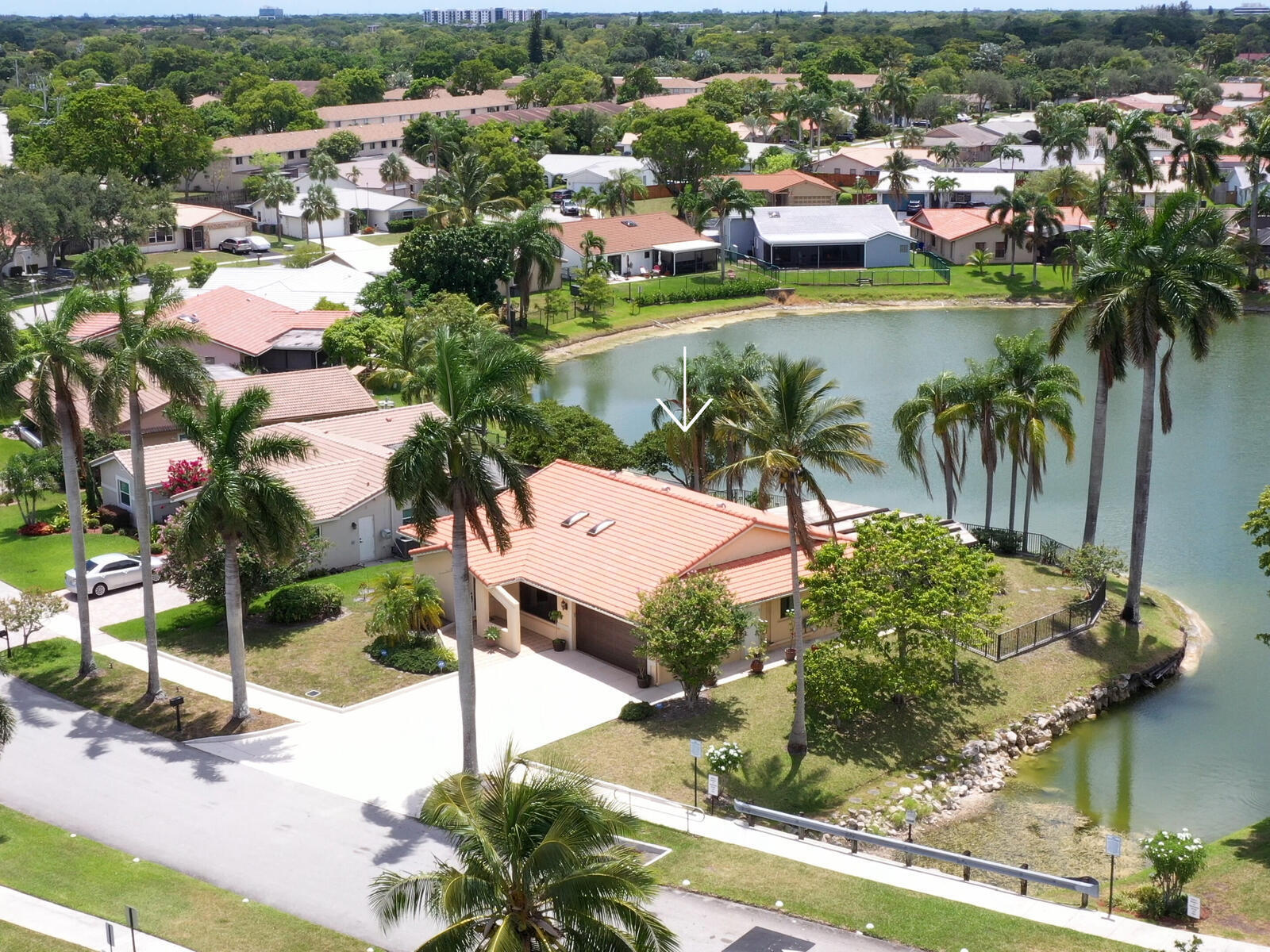 We're thrilled to present this lovely 4-bedroom, 2-bath home, offering breathtaking lake views and picture-perfect sunsets from your expansive screened and roofed patio. Experience the best of Florida living-ideal for family gatherings, holidays, and creating cherished memories. You'll be welcomed by vaulted ceilings and an abundance of natural light. The open kitchen and family room features S.S. appliances only 3 years, granite counter tops, and wood cabinets. Every window, door and garage door are high-impact, providing excellent protection and significantly reducing insurance costs. Other exceptional features include inside laundry room, parking for over 8 vehicles, cost saving sprinkler system off the lake, hot water heater 2 years, and flourishing mango, coconut, and avocado trees!