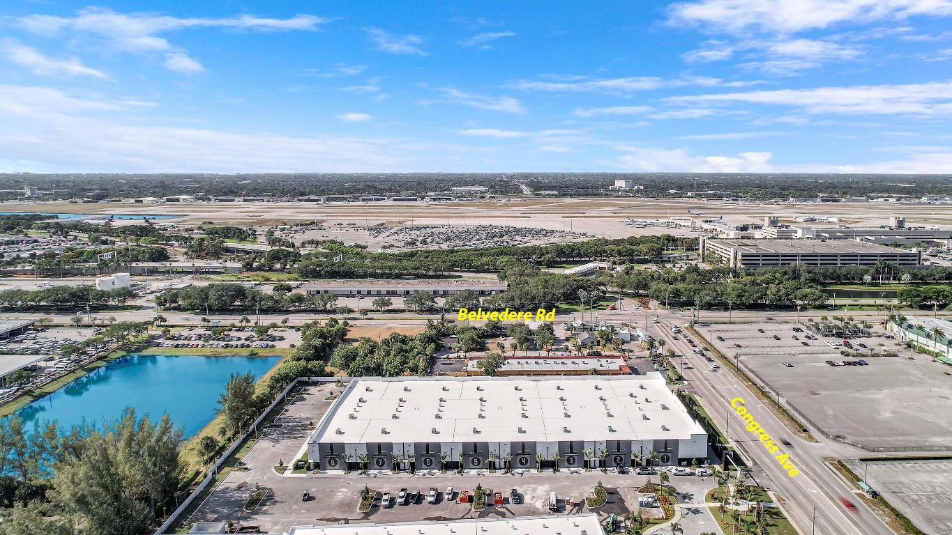 Situated adjacent to The Hangar, virtually in sight and walking distance of the  PBI Airport, Airfield Park offers the perfect solution for enthusiasts seeking secure storage for their valuable assets including; wine, art, and automobile collections. Totalling 81,992 sqft w/ 16 Units ranging from 5,011 to 5,884 square feet standard with a private ADA compliant restroom. Solid concrete tilt wall construction with 14' x 14' Miami Dade Hurricane Rated insulated garage and pedestrian doors. Latest AI technology security with live monitoring. Featuring a state-of-the-art conference center, complete with a boardroom and expansive event space.   Select businesses are allowed to operate within Airfield Park with prior Association approval. Private tours available with select and qualified buyers
