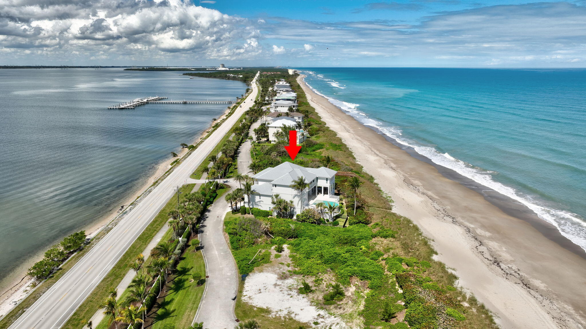 Exceptional custom-built oceanfront estate in a private gated enclave with 100 feet of pristine beach & stunning sunrise/sunset views. Designed for both entertaining and relaxed coastal living, this turnkey, fully furnished home features expansive covered outdoor space with built-in grill, fireplace, resort-style pool and outdoor shower. Boaters can enjoy a 50-foot private dock with easy Intracoastal and ocean access, while sea turtles and dolphins are just steps away. Interior highlights offer a great room opening to outdoor living, pub room with bar, theater seating for 12, professional kitchen with commercial grade appliances, large island with walk-in pantry. Sleeps 16 with five en-suite bedrooms with terraces, bunk room, oversized ocean view primary suite, elevator & 8 car garage.