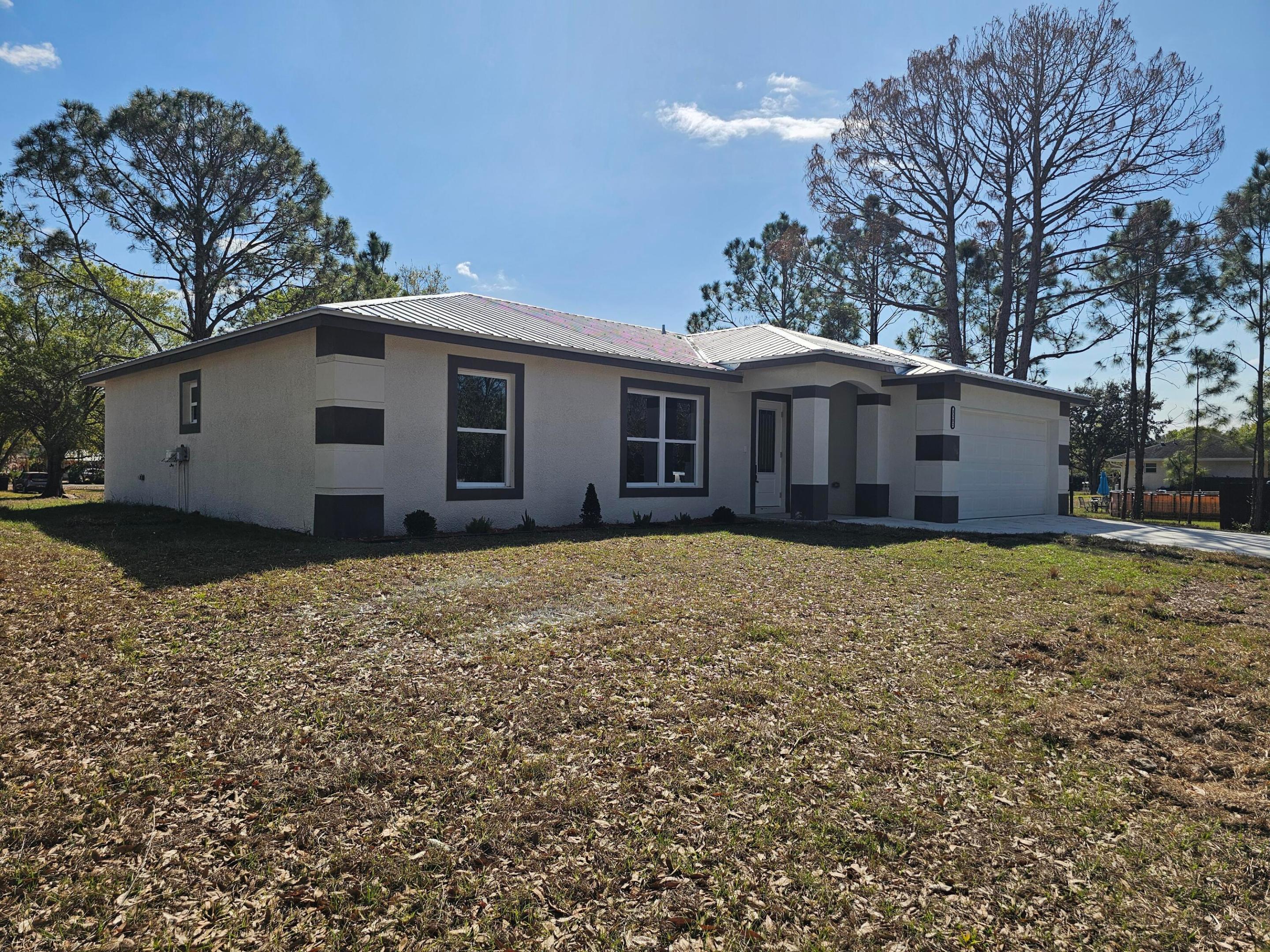 Basswood~Welcome to this brand-new construction 2025, 3Bed-,2Bath custom home built using quality material houghtful upgrades, and modern finishes throughout. Designed for comfort, style, and lasting value. Sits on an oversized acre with a Metal roof, in scenic Okeechobee County. A unique modern/elegant home, under 1,485SqFt TLA 1,941SaFt. Features: an open-concept living and split floor plan with dining area that connects seamlessly into a modern kitchen with stainless steel appliances with soft closed cabinets and Quartz countertops. Spanish Porcelain tiles throughout and Indian porcelain on each bathroom. Spacious rooms, complete with double sinks. Main suite with large walk-in closet. Interior laundry with washer/dryer. 2 Car attached garage. Impact windows. On water well and septic.  On septic, Ceiling fans. Rain gutters. No HOA in growing community. Enjoy quiet evenings on the back patio. Call today for a free Tour!