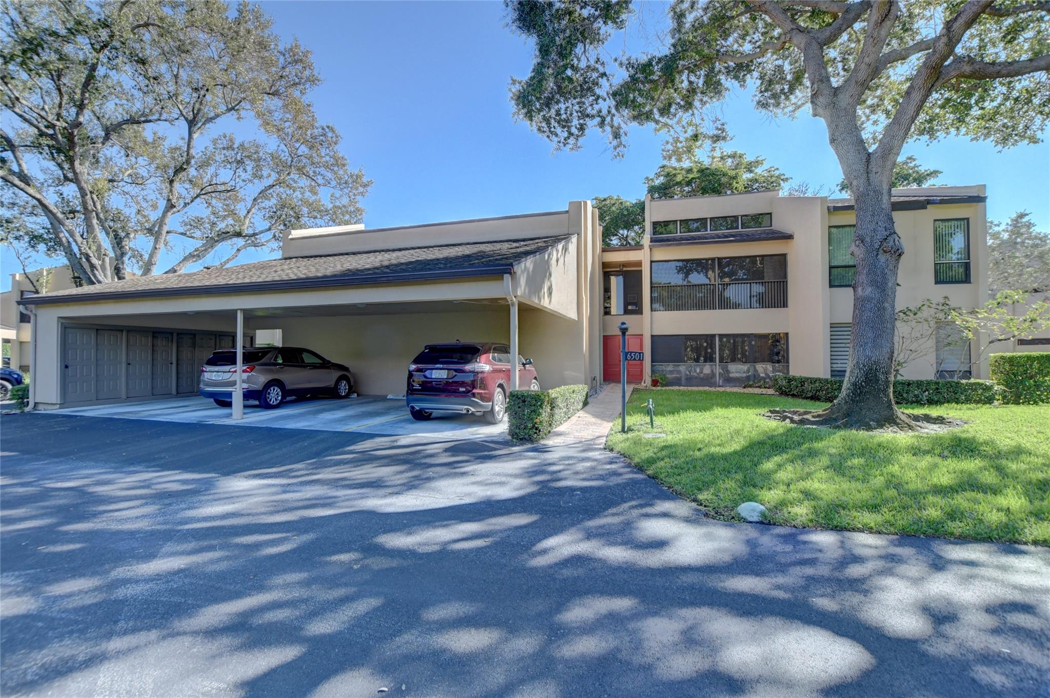 Explore this 2nd-floor corner unit condo where vaulted ceilings create a spacious ambiance and elegant crown molding adds a touch of sophistication. The entire space features porcelain tile accentuated by 5-inch baseboards. Newer kitchen with granite countertops. Enjoy the convenience of a washer & dryer right in the unit. The enclosed balcony provides additional living space. Hurricane Impact glass windows throughout, except for patio sliders. Two of the bedrooms offer serene lake views and boast generous walk-in closets. The AC unit was replaced in 2019. The building provides a secured interior lobby, a one-car carport with additional storage,  and ample guest parking. No dogs allowed. Nice pool and clubhouse. Excellent location, close to shops, restaurants, major roads and beaches.