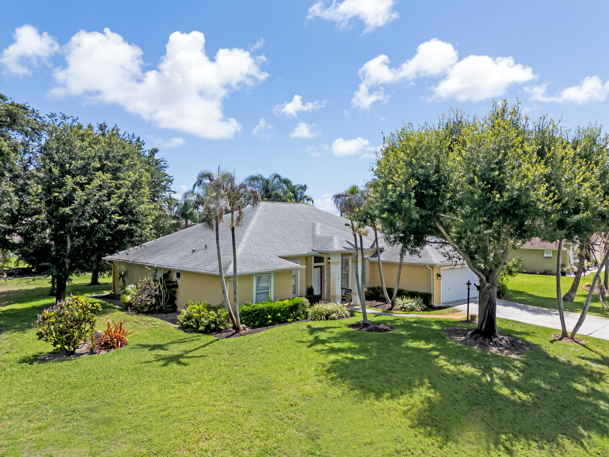 Welcome to Paradise!  Impressive Custom-Built CBS, One Owner, 4 Bedrooms, 3 Full Bathrooms, 2 car Garage on .47 of an Acre of Mature Landscaping with screened in Patio in Sandpiper Bay Community!  Prepare to be Impressed!  Elegant Foyer invites you into the Formal Dining Room, Formal Living Room or spacious Family Room w/ French Doors to Screened Patio.   Tile Flooring throughout main living area.  Spacious Eat-In Kitchen w/ S.S. Appliances, Granite Countertops and Snack Counter. Primary Bedroom, w/ carpeting, features French Doors to Patio w/ spacious Bathroom Suite.  Double Walk-In Closets.  Guest Bedrooms were thoughtfully planned.  2 Bedrooms, w/ carpeting, share a Full Bathroom, the Rear Bedroom, w/ laminate floor, has Full Bathroom w/ access to the Patio Area. *See Broker Remarks.