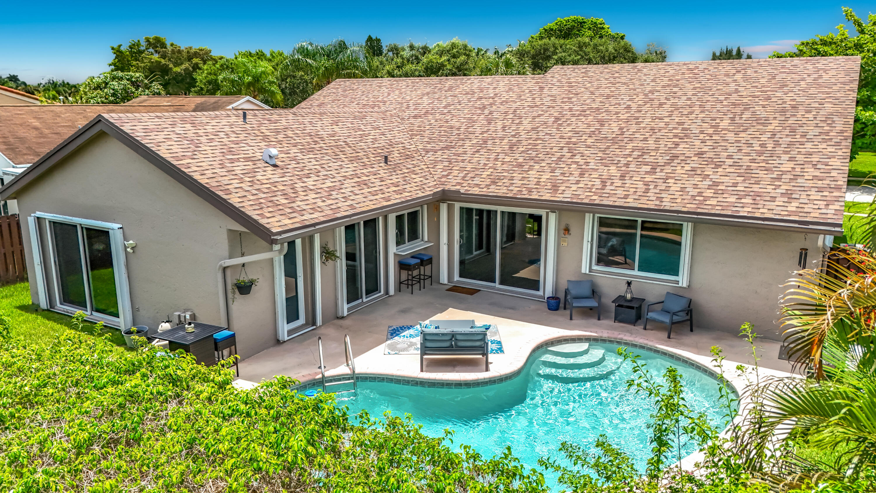 Welcome to this well-appointed single-story residence in Weston, FL. This home is surrounded by lush landscaping and features a tranquil pool area—perfect for relaxing or entertaining. Substantially updated with impact windows and new roof. Featuring Tile floors throughout, Vaulted ceilings, billiards/flex area and eat-in kitchen that is tastefully updated with quartz countertops-complementing the home's modern feel. The thoughtfully designed triple-split floor plan provides privacy and space for everyone. Spacious primary with sitting area and large updated bathroom. Located in an establish community with NO hoa and includes Town Center amenities with an annual fee of $420, offering a variety of recreational and lifestyle benefits. Must see--a real gem!