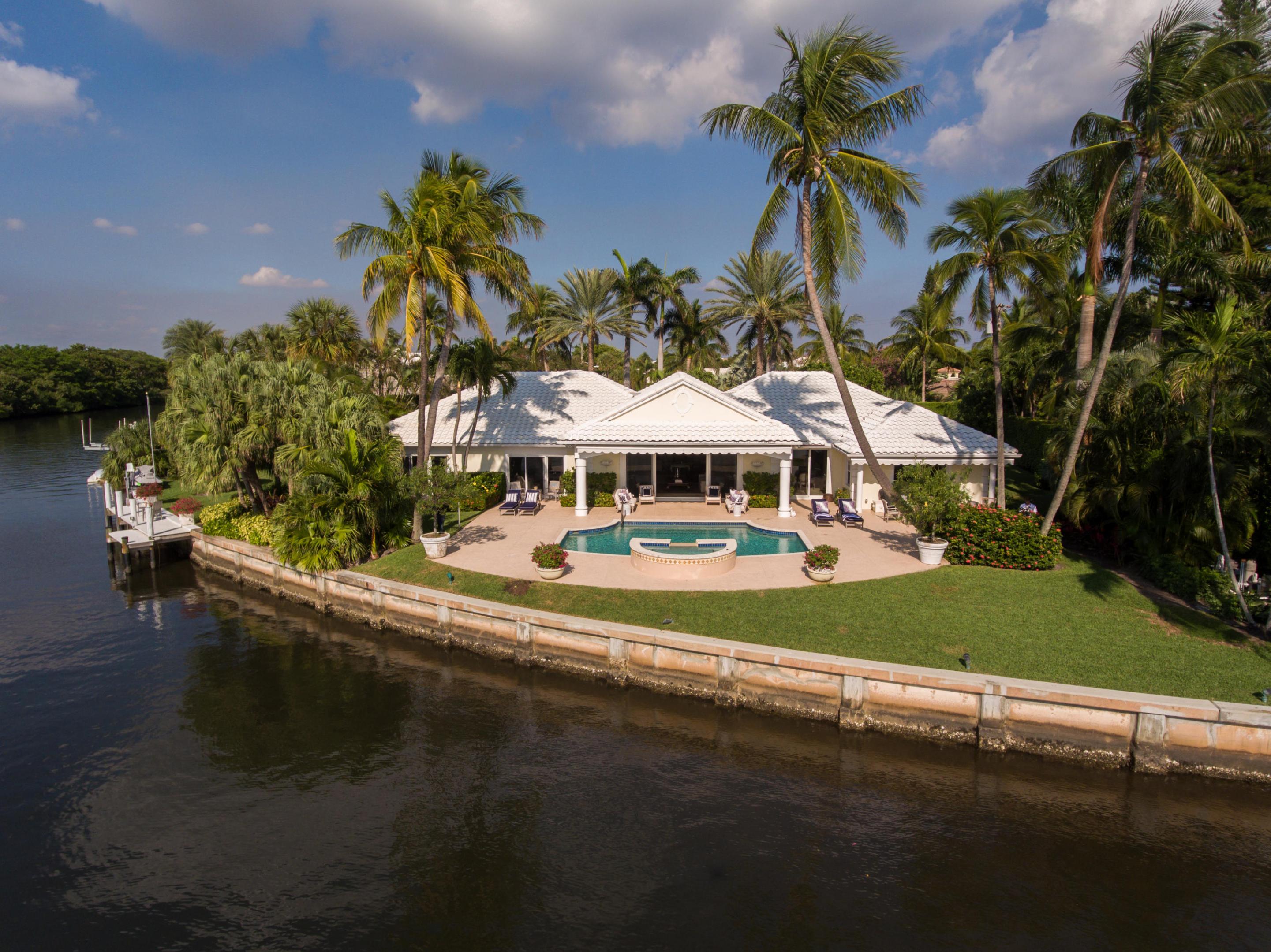 Enter this lavish Bermuda-Style Waterfront Estate through a limestone clad motor court, flanked by royal palms and tropical landscape,an oasis for indoor and outdoor entertaining. This intracoastal estate sits on over a half acre with 208 feet of direct uninterrupted water views.This Estate home features 5,646 total square feet. A grand-foyer leading into a large living and dining room featuring vaulted cypress ceilings, a fireplace and wet bar. Walk directly outdoors from the family room to an unsurpassed setting of the pool and spa, with lush tropical landscaping and endless sunsets.... Four en-suite bedrooms, with four and one half private baths. Master suite with his/her baths, large walk-in closets with full views of the water. 

Prime Location with bright Southern views.