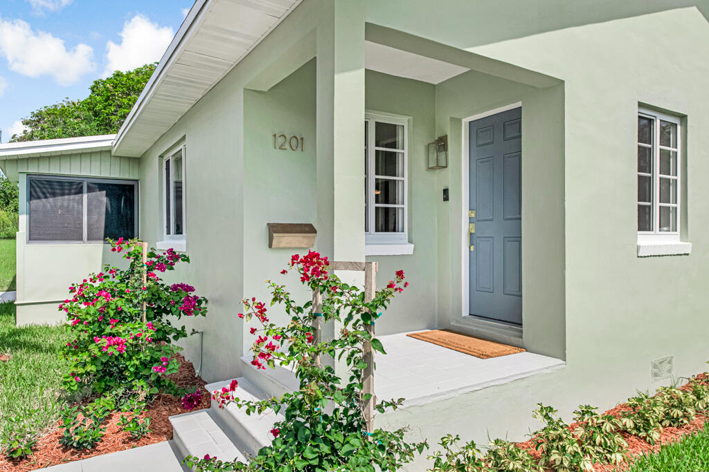 Welcome to 1201 N Palmway — a turnkey gem in one of Lake Worth Beach's most coveted neighborhoods, where parrots nest in the trees and downtown's bistros, cafés, and the Intracoastal are all just a stroll away. Forget "updated." This home has been rebuilt from the street in. Everything is brand new: a 2025 roof, all-new 2026 plumbing and electrical wiring throughout, brand-new hurricane impact windows and doors, and ---for the first time ever — central air conditioning. Step inside to a brand-new kitchen with new appliances and lighting, fully renovated baths with new toilets and tubs, a new water heater, and a new washer and dryer. Every fixture, every system, every finish: new.  The result is the rarest find in a historic neighborhood ,all the charm and walkable lifestyle of Parrot Cove. with none of the maintenance worries of an older home. Impact glass means lower insurance, year-round peace of mind, and a quiet, energy-efficient home. Move in, exhale, and enjoy. Live steps from Lake Avenue's dining and nightlife, the Saturday farmers market at Old Bridge Park, the golf course, and the water. This one won't last.